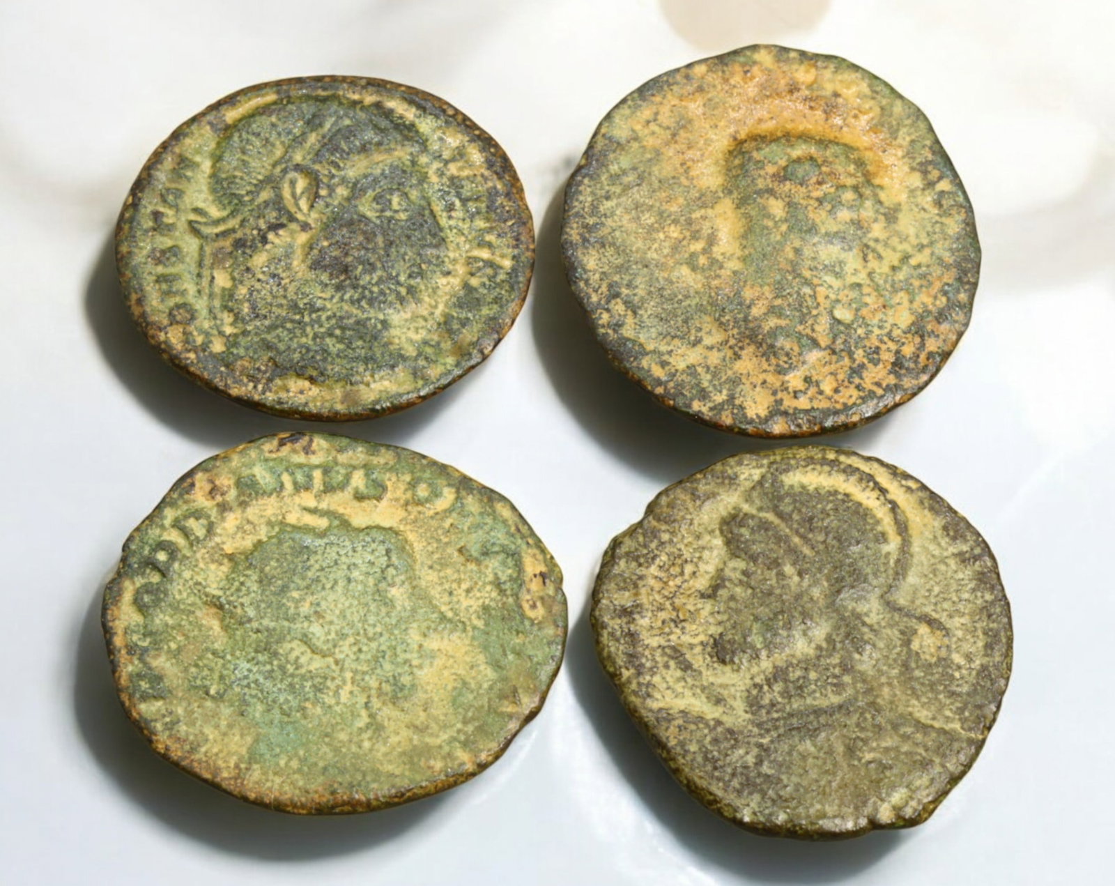 ROMAN EMPIRE: AE Coins - Bronze Coins, 19-20mm, 9g (Lot of 4): A collection of ancient Roman bronze coins, each featuring a distinct imperial portrait on the obverse and various symbolic or military-themed reverses. These coins, essential to Roman commerce and go
