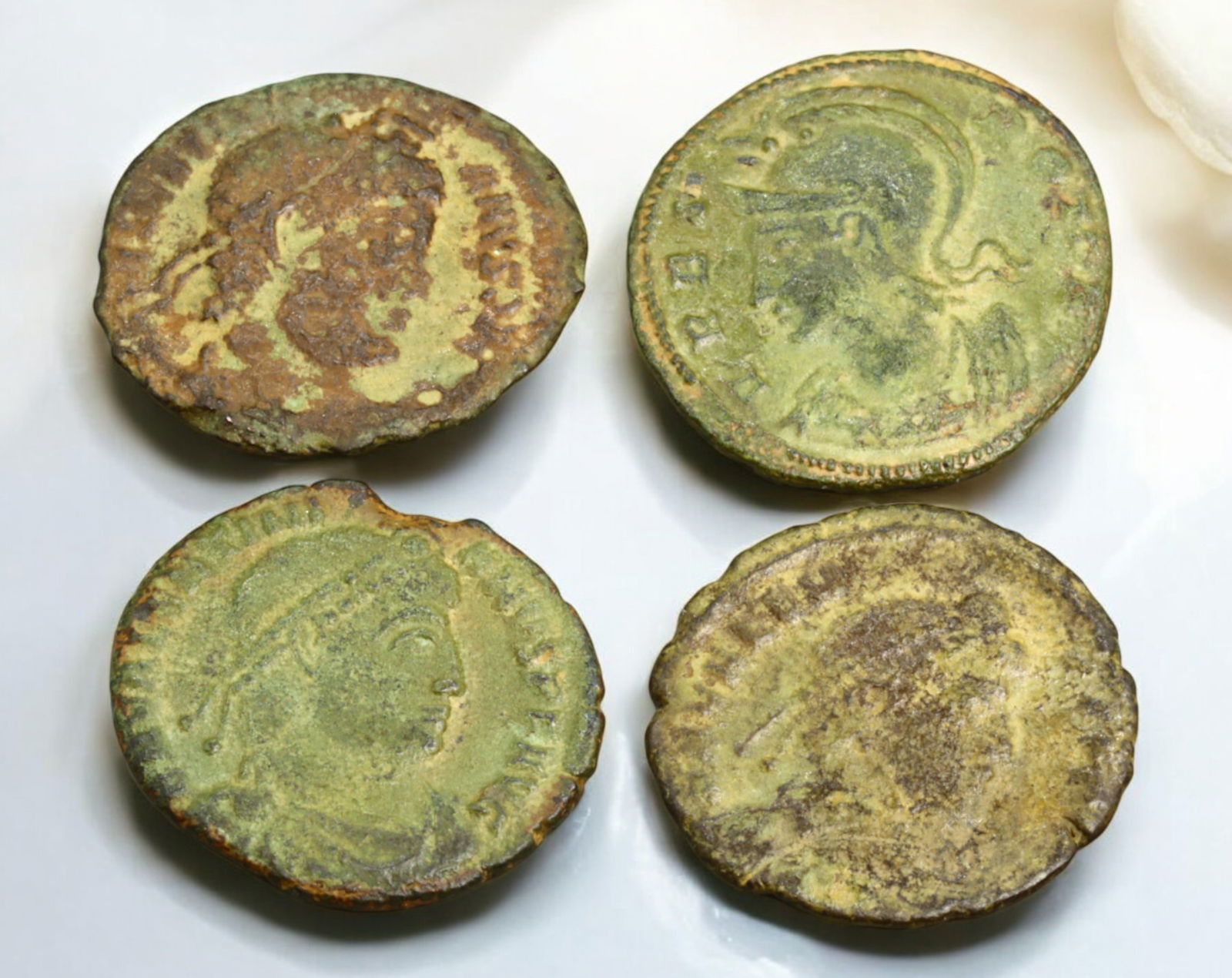 ROMAN EMPIRE: AE Coins - Bronze Coins, 18-19mm, 8g (Lot of 4): A collection of ancient Roman bronze coins, each featuring a distinct imperial portrait on the obverse and various symbolic or military-themed reverses. These coins, essential to Roman commerce and go