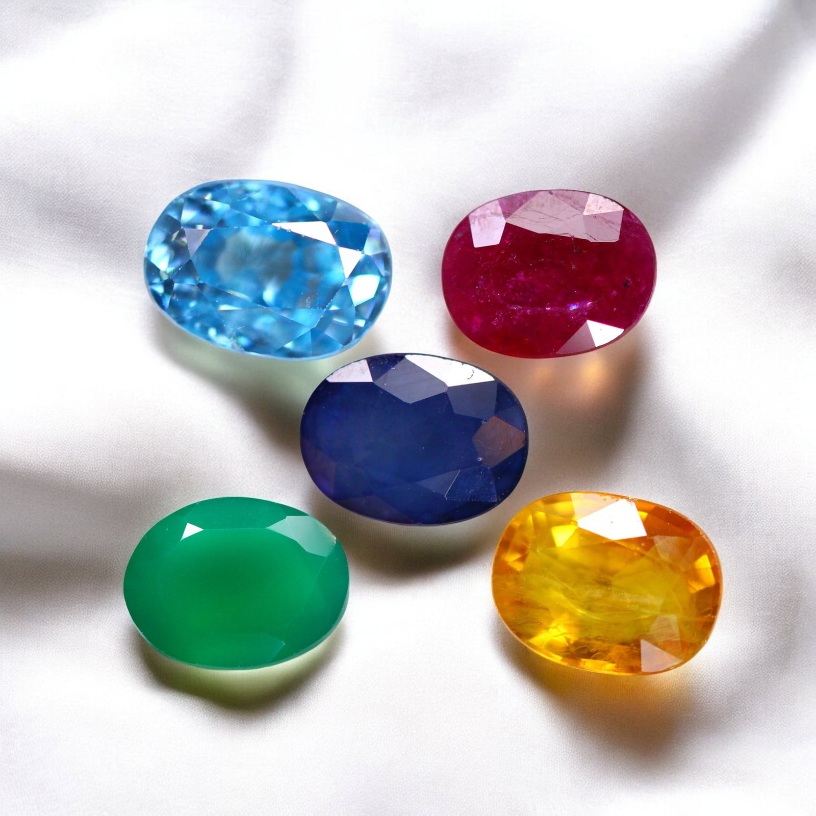 Blue Sapphire, Green Onyx, Yellow Sapphire, Blue Zircon & Ruby: A spectacular collection of five exquisite gemstones, each featuring vibrant hues, exceptional clarity, and expert faceting. The Blue Sapphire (1.67ct, 8.1x6.0x3.6mm) exhibits a rich, deep blue color,