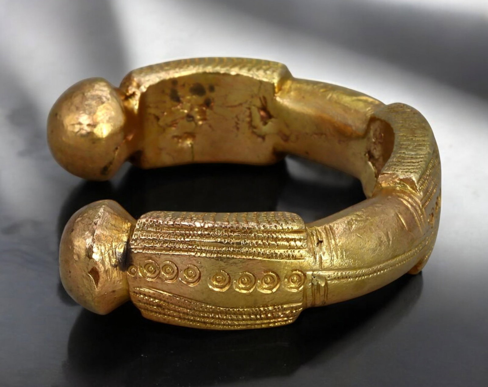 AFRICAN TRADE: Manilla Bracelet Gold-Tone Currency Cuff, West Africa, 6.8 x 1.7 cm: Heavy with history and presence, this traditional West African manilla bracelet once served both as adornment and a medium of exchange. Measuring 6.8 x 1.7 cm and weighing an impressive 141 g, it is c