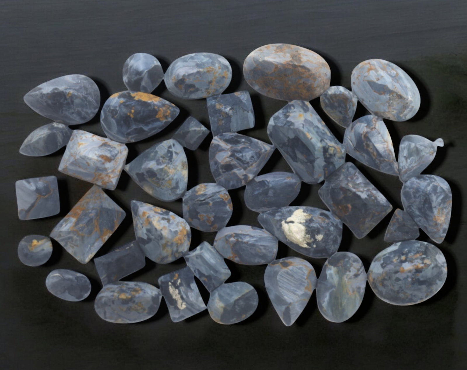 NAMIBIA: Pietersite Preform Cabochon Lot - 52g, 10-20mm, Unpolished Natural Specimens: A fine selection of unpolished Pietersite cabochon preforms from Namibia, weighing 52g, with individual pieces ranging from 10mm to 20mm. These stunning stones display the signature blue, gray, and go