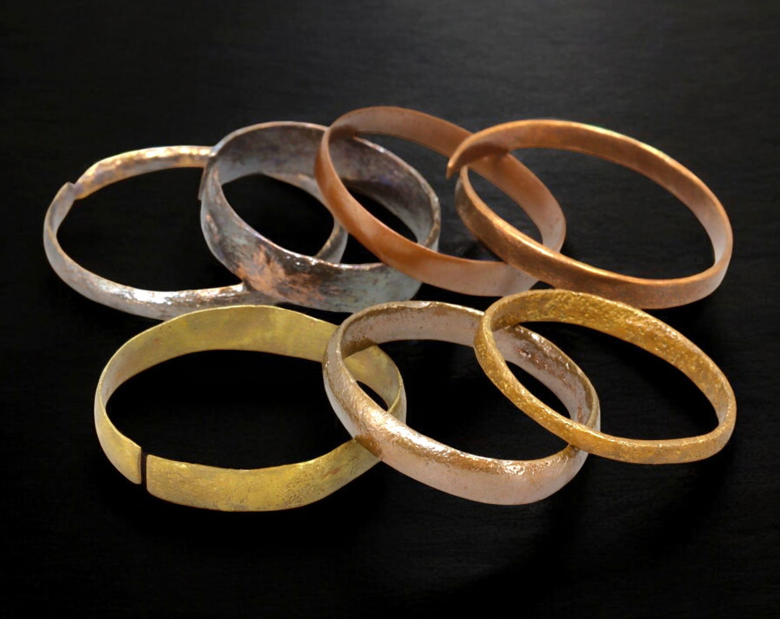 VIKING AGE: Lot of Bronze & Brass Engagement or Wedding Rings - 9th-11th Century: A captivating set of Viking-era engagement or wedding rings, crafted in bronze and brass. These finely shaped rings exhibit a rich patina, with some featuring smooth, polished surfaces while others re