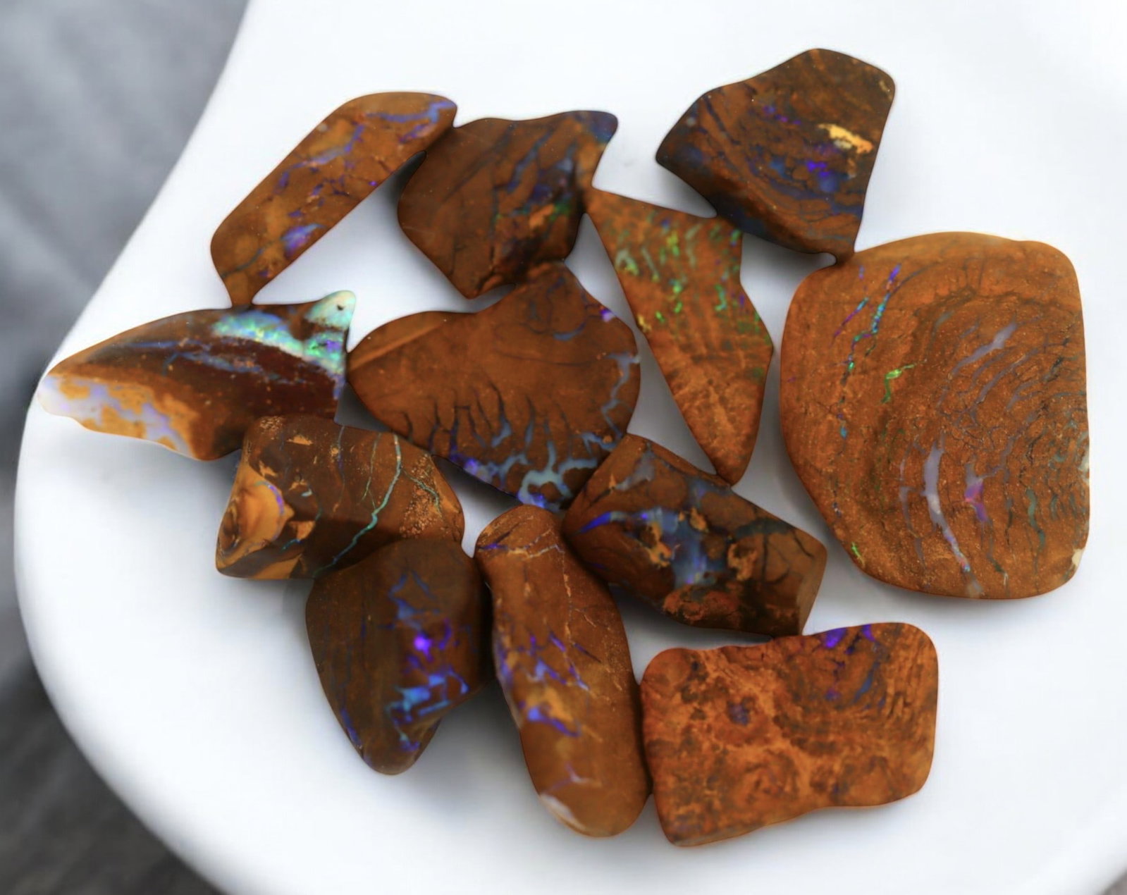 AUSTRALIAN MATRIX BOULDER OPAL - Rough Lot, 1.5-2.5cm, 24g: A striking lot of natural Australian matrix boulder opal rough. These raw specimens display mesmerizing flashes of blue, green, and gold veins running through ironstone, characteristic of high-quality