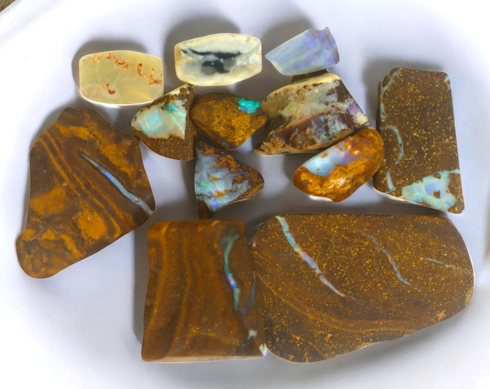 AUSTRALIA: Matrix Boulder Opal Rough Lot, 36g, 1-3.3 cm (Images Taken Wet): Stunning lot of natural Australian matrix boulder opal rough, these specimens showcase a vibrant interplay of opalized veins and swirls embedded in rich ironstone, displaying flashes of electric blues