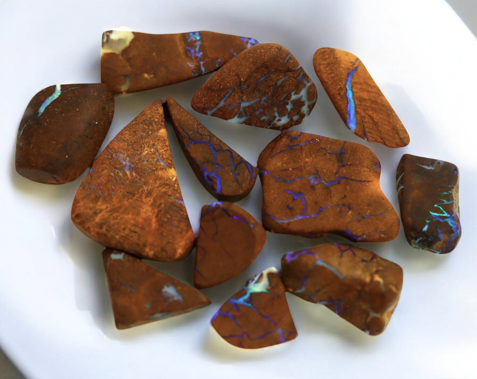 AUSTRALIAN MATRIX BOULDER OPAL - Rough Lot, 1-2cm, 15g: A striking lot of natural Australian matrix boulder opal rough. These raw specimens display mesmerizing flashes of blue, green, and gold veins running through ironstone, characteristic of high-quality