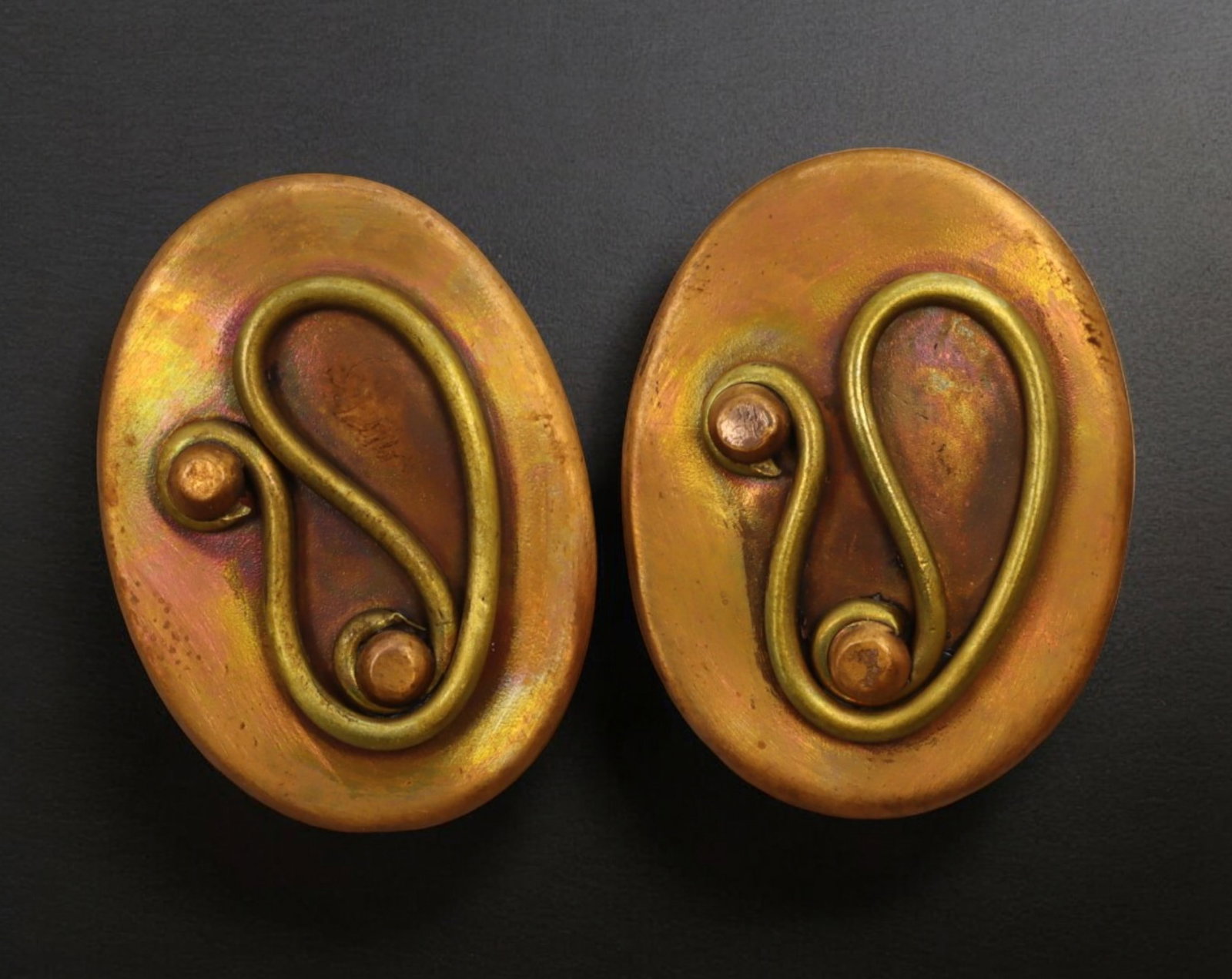 MID-CENTURY MODERNIST: Earrings - Gilt Brass Clip-Ons, Signed Chenet, Haiti, ca. 1960s: This striking pair of 3 x 2 cm clip-on earrings, weighing a combined 9.2 grams, showcases warm-toned gilt brass ovals adorned with applied sculptural wirework in an expressive abstract motif. The reve
