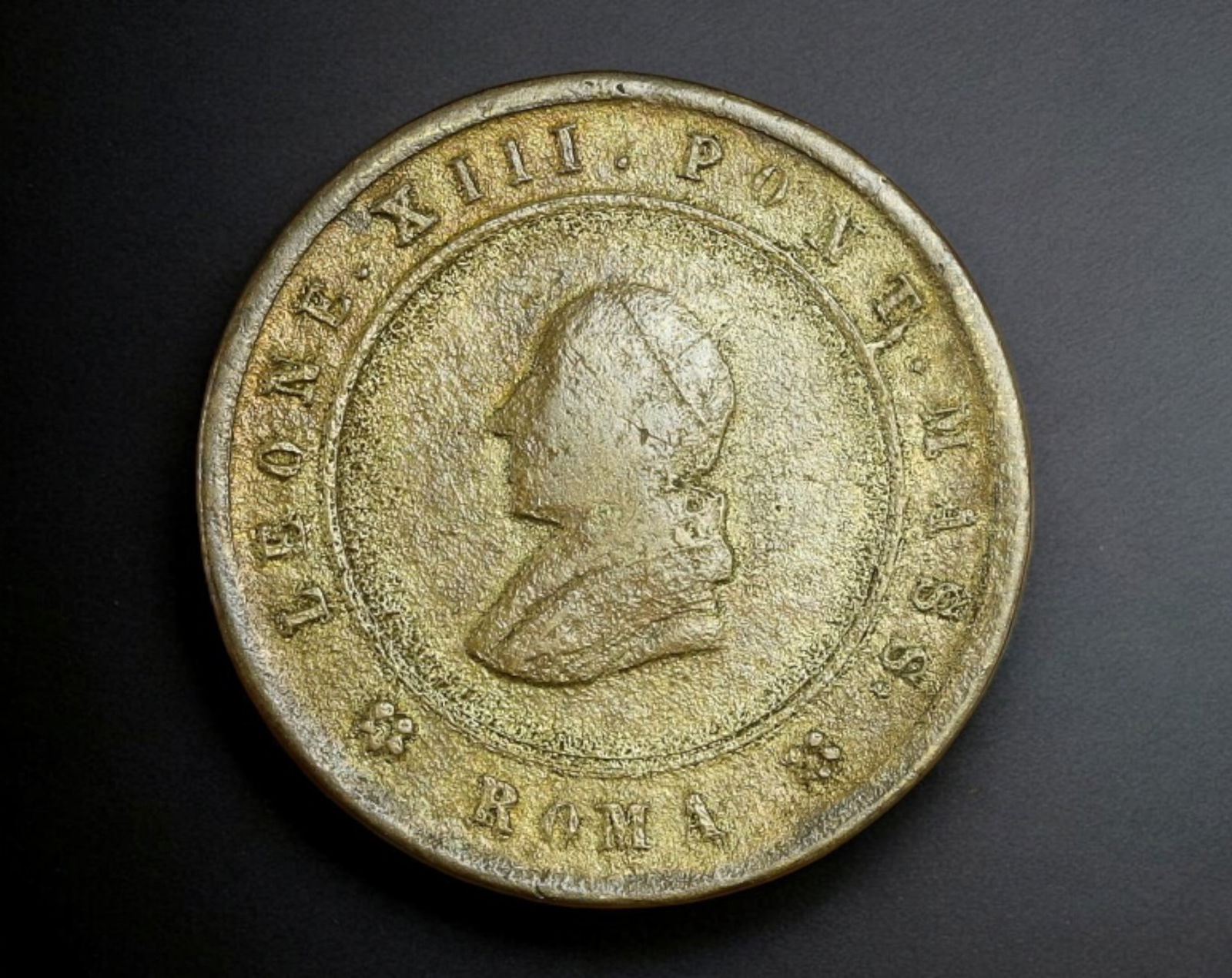 VATICAN CITY: Pope Leo XIII - Brass 10 Centesimi, Roma Mint, Year XXIII (1900): Struck in brass at the Papal Mint in Rome, this 10 Centesimi coin weighs 3.3g and measures 2.1 cm in diameter, issued during the 23rd year of Pope Leo XIII's pontificate. The obverse features a left-f