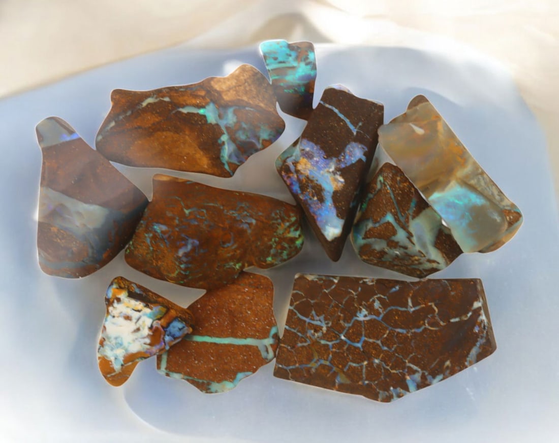 AUSTRALIAN MATRIX BOULDER OPAL - Rough Lot, 41g, 1-3.2cm (Images Taken Wet): A striking lot of natural Australian matrix boulder opal rough. These raw specimens display mesmerizing flashes of blue, green, and gold veins running through ironstone, characteristic of high-quality