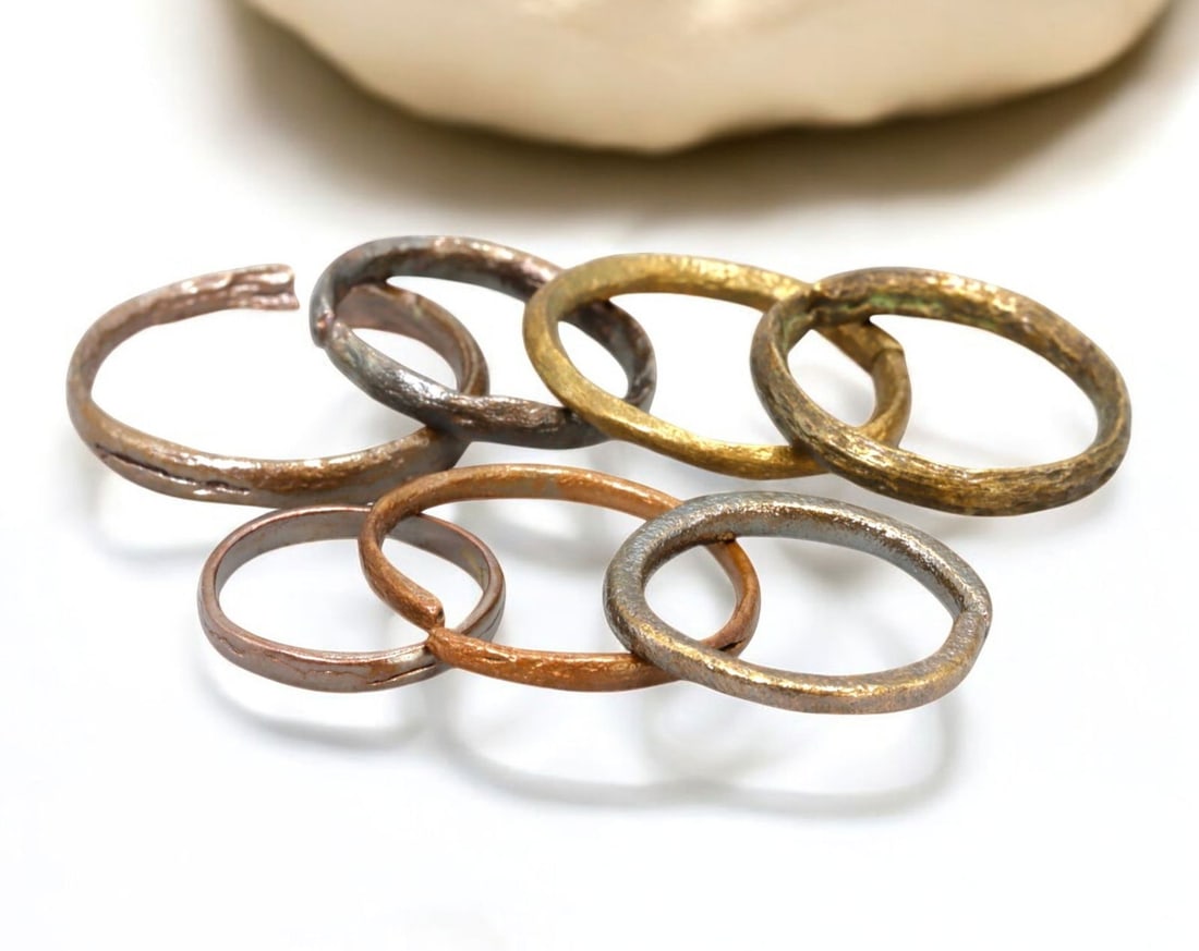 VIKING AGE: Lot of Bronze & Brass Engagement or Wedding Rings - 9th-11th Century: A captivating set of Viking-era engagement or wedding rings, crafted in bronze and brass. These finely shaped rings exhibit a rich patina, with some featuring smooth, polished surfaces while others re