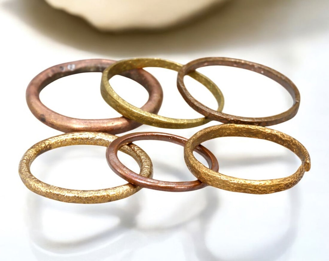 VIKING AGE: Lot of Bronze & Brass Engagement or Wedding Rings - 9th-11th Century: A captivating set of Viking-era engagement or wedding rings, crafted in bronze and brass. These finely shaped rings exhibit a rich patina, with some featuring smooth, polished surfaces while others re