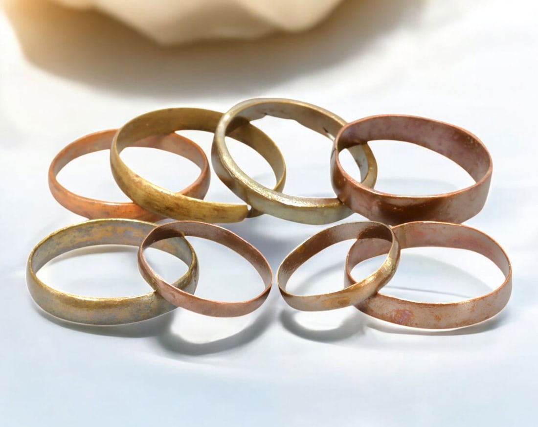 VIKING AGE: Lot of Bronze & Brass Engagement or Wedding Rings - 9th-11th Century: A captivating set of Viking-era engagement or wedding rings, crafted in bronze and brass. These finely shaped rings exhibit a rich patina, with some featuring smooth, polished surfaces while others re