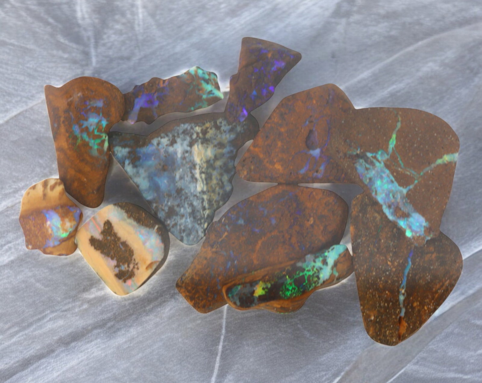 AUSTRALIAN MATRIX BOULDER OPAL - Rough Lot, 27g, 1-3cm (Images Taken Wet): A striking lot of natural Australian matrix boulder opal rough. These raw specimens display mesmerizing flashes of blue, green, and gold veins running through ironstone, characteristic of high-quality