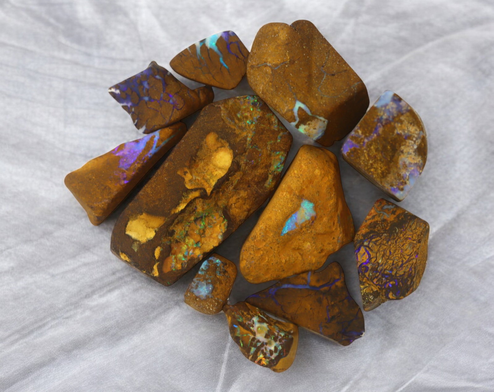 AUSTRALIA: Matrix Boulder Opal Rough Lot, 40g, 1-3.6 cm (Images Taken Wet): Stunning lot of natural Australian matrix boulder opal rough, these specimens showcase a vibrant interplay of opalized veins and swirls embedded in rich ironstone, displaying flashes of electric blues