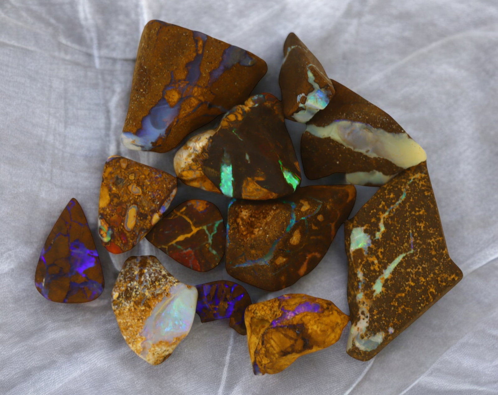 AUSTRALIA: Matrix Boulder Opal Rough Lot, 24g, 1-2.9 cm (Images Taken Wet): Stunning lot of natural Australian matrix boulder opal rough, these specimens showcase a vibrant interplay of opalized veins and swirls embedded in rich ironstone, displaying flashes of electric blues