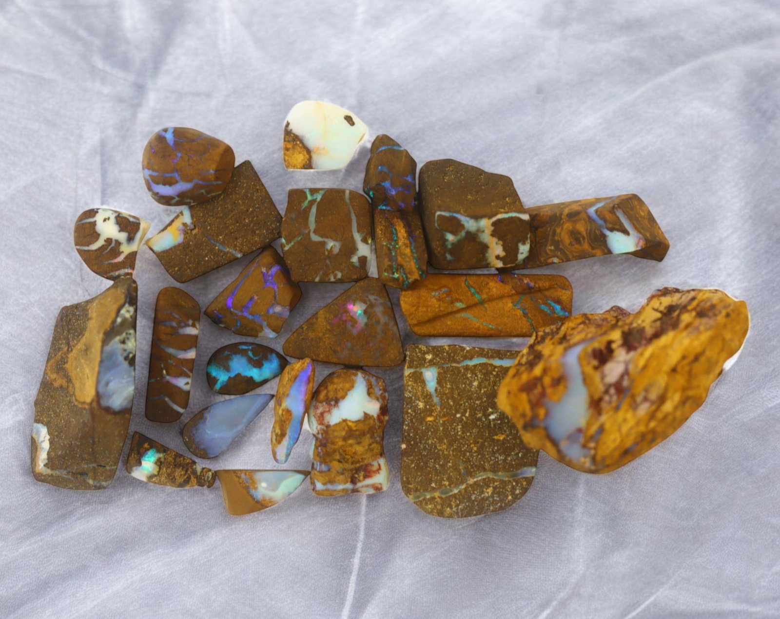 AUSTRALIA: Matrix Boulder Opal Rough Lot, 38g, 1-3.3 cm (Images Taken Wet): Stunning lot of natural Australian matrix boulder opal rough, these specimens showcase a vibrant interplay of opalized veins and swirls embedded in rich ironstone, displaying flashes of electric blues