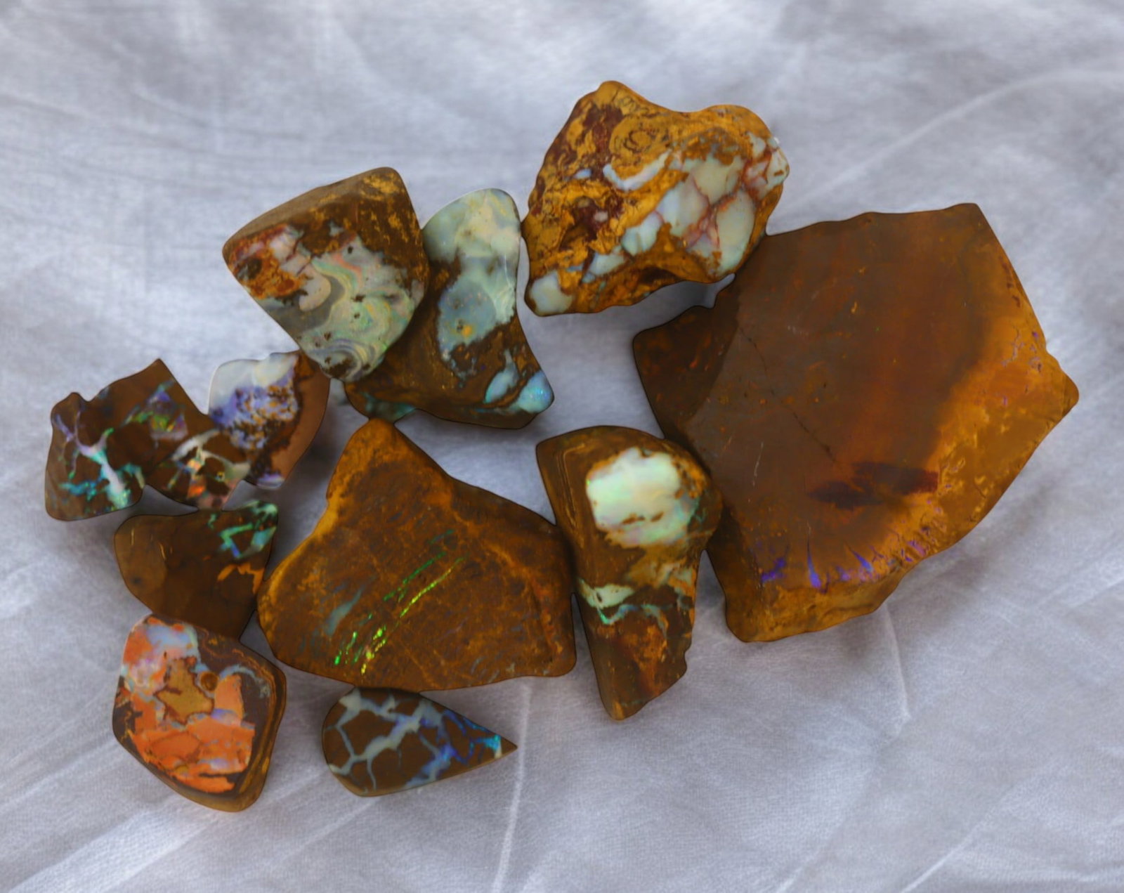 AUSTRALIA: Matrix Boulder Opal Rough Lot, 33g, 1-3 cm (Images Taken Wet): Stunning lot of natural Australian matrix boulder opal rough, these specimens showcase a vibrant interplay of opalized veins and swirls embedded in rich ironstone, displaying flashes of electric blues