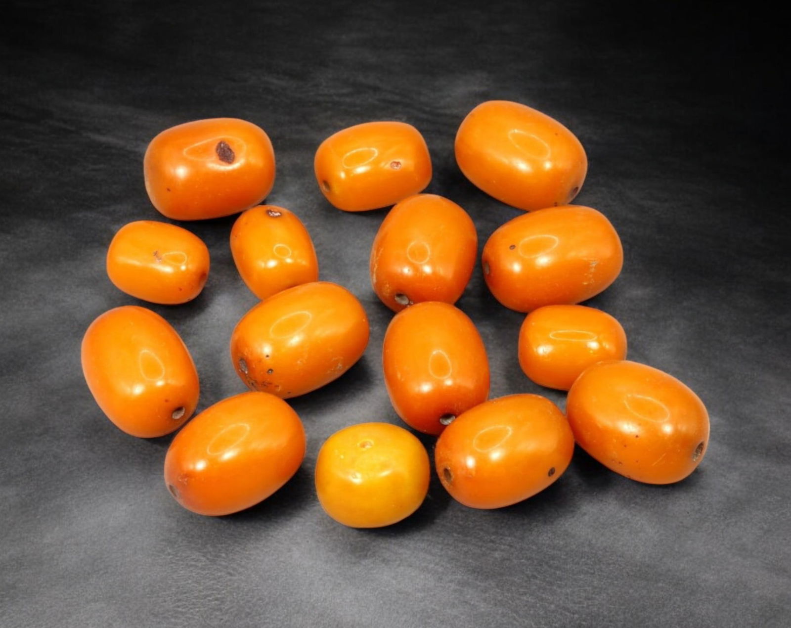 AFRICAN: Antique Amber Resin Beads, (73g, 2.5cm): This striking lot features African antique amber resin beads, weighing a total of 73 grams with individual beads measuring approximately 2.5cm in size. These warm-hued, barrel-shaped beads display a r