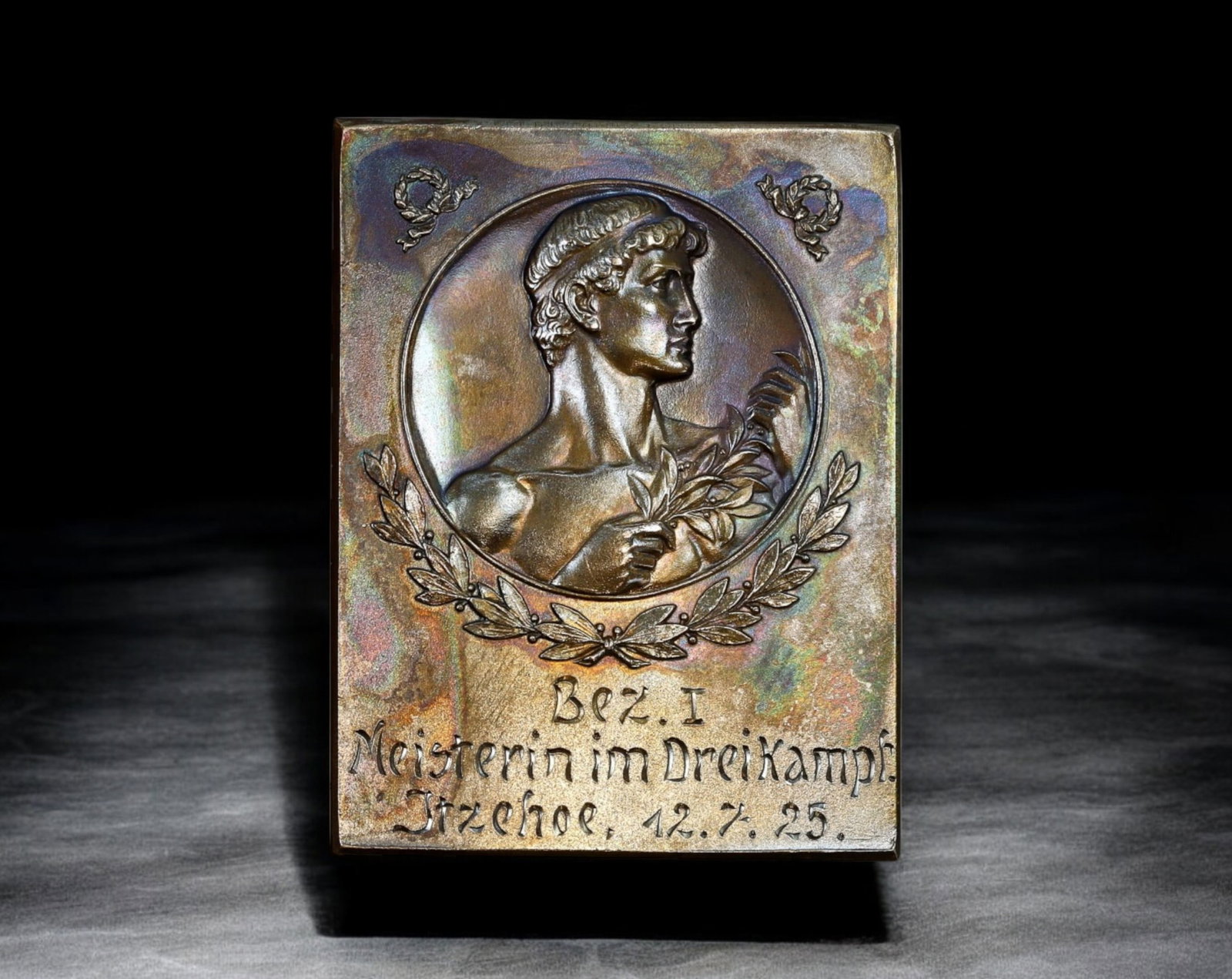 GERMANY: Rectangular Sports Award Plaque - Bezirksmeisterin im Dreikampf, Itzehoe, 1925: A finely crafted rectangular sports award plaque, measuring 60mm x 39mm and weighing 39g, awarded for the Bezirksmeisterin (regional champion) in Dreikampf (triathlon-style event) in Itzehoe on July 1