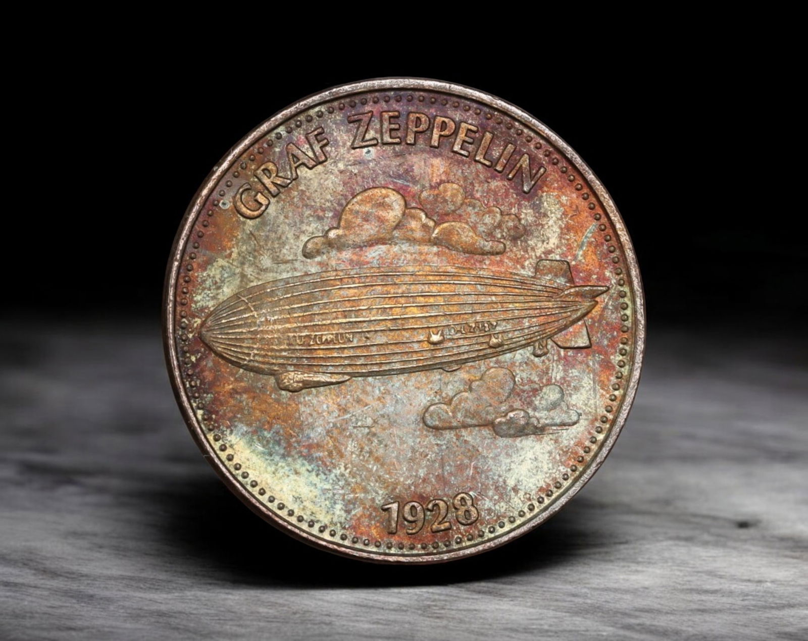 GERMANY: Shell Oil Advertising Token - Graf Zeppelin Airship, Aluminum-Bronze, 1928: Struck in aluminum-bronze and measuring 2.6 cm in diameter with a weight of 5g, this 1928 token commemorates the iconic LZ 127 Graf Zeppelin, one of the most celebrated airships in aviation history. T