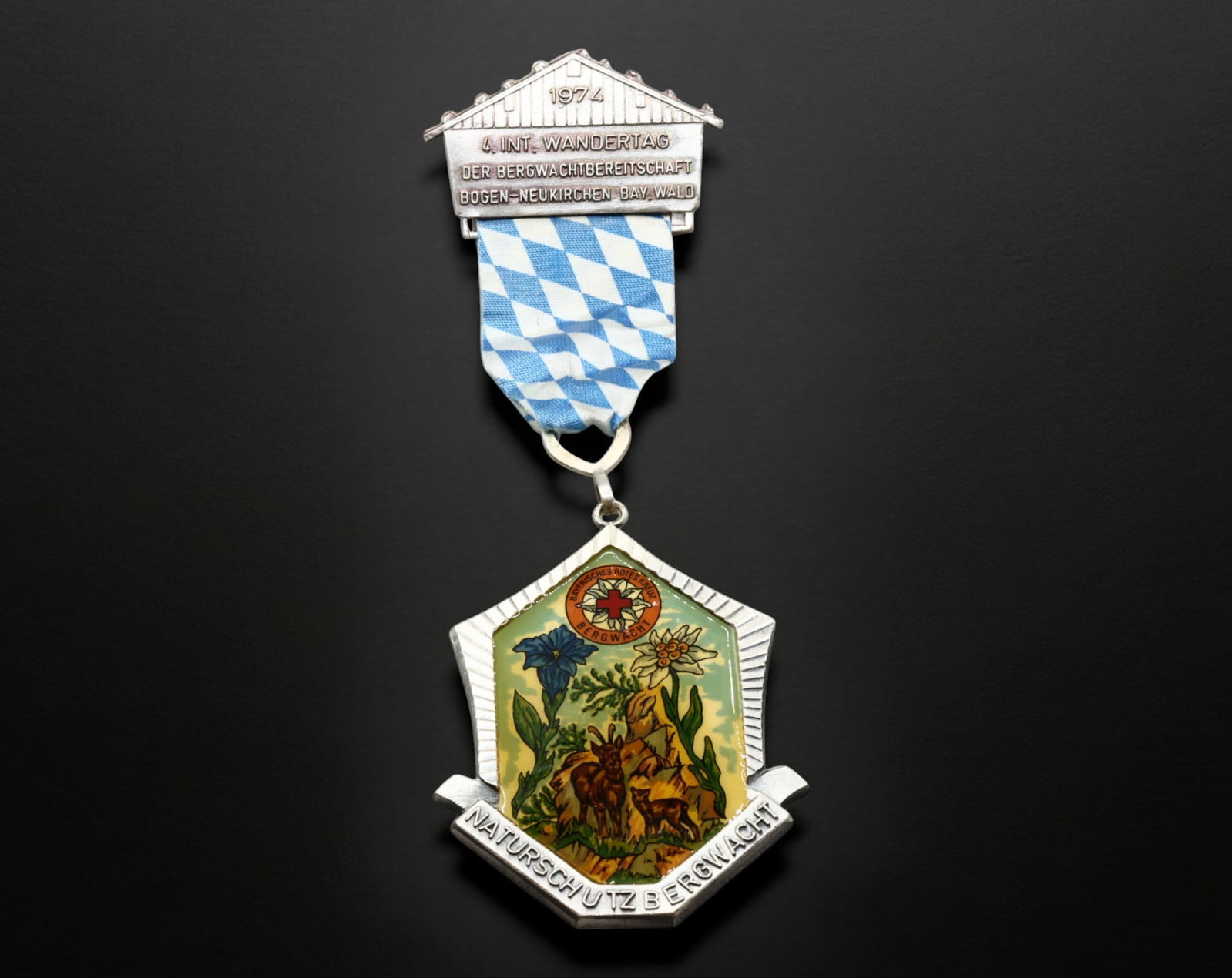 GERMANY: 4th International Wandertag Bergwacht Badge - Naturschutz & Bergwacht, 1974: A striking silver-tone and enamel hiking badge, issued for the 4th International Wandertag (Hiking Day) of the Bergwacht (Mountain Rescue) in Bogen-Neukirchen, Bavaria/Wald, 1974. This two-part medal,