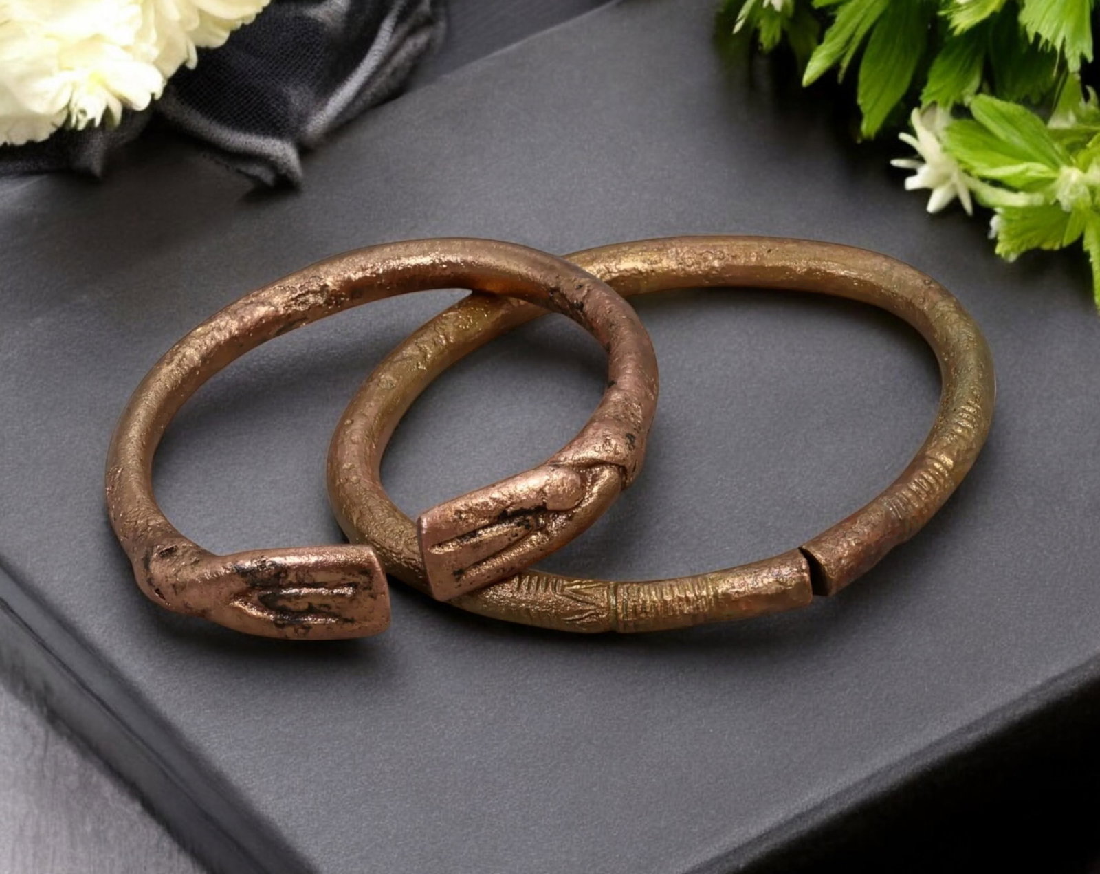 WEST AFRICA: Pair of Cast Bronze "Handshake" Manilla Currency Bracelets - 6.7-8.5cm, 131g, Circa: This striking pair of bronze manilla currency bracelets showcases the "handshake" motif, a rare and symbolically significant design found in West African trade economies. These pieces exhibit finely c