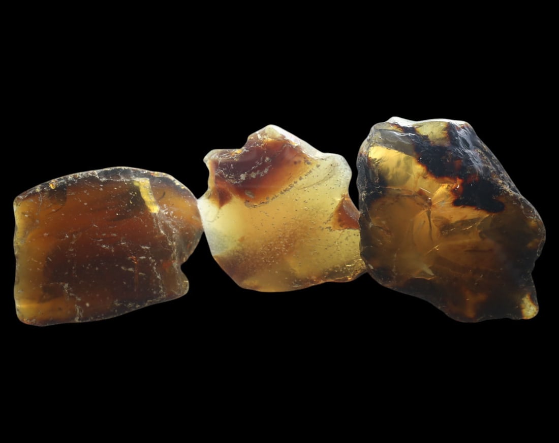 NATURAL: Baltic Amber Specimen Rough - 95g, 4-7cm, Fossilized Tree Resin: A stunning set of raw Baltic amber specimens, these unpolished pieces display rich golden hues with deep brown inclusions, characteristic of high-quality fossilized tree resin. The translucency and na