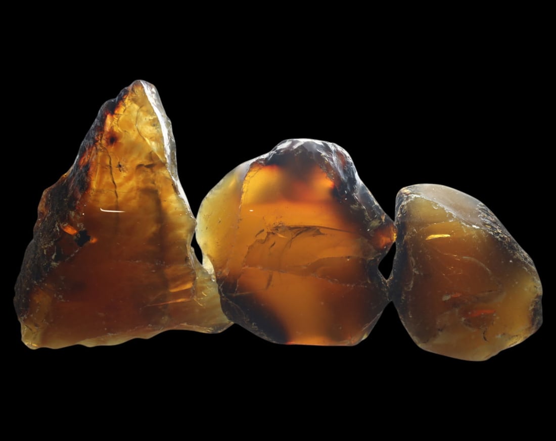 NATURAL: Baltic Amber Specimen Rough - 84g, 5-7.5cm, Fossilized Tree Resin: A stunning set of raw Baltic amber specimens, these unpolished pieces display rich golden hues with deep brown inclusions, characteristic of high-quality fossilized tree resin. The translucency and na