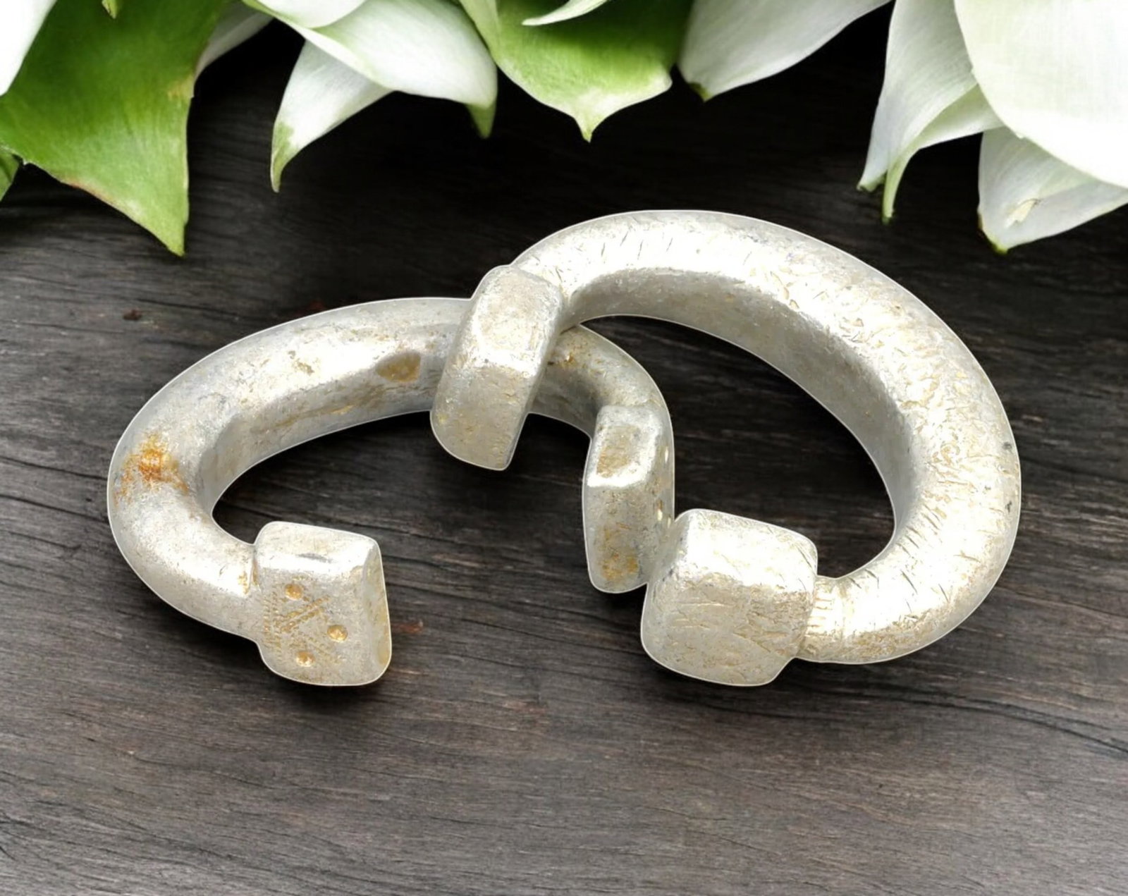 WEST AFRICA: Bamileke Square-Terminal Aluminum Currency Bracelets - 7.5-8cm, 142g, 19th/20th: A bold and substantial pair of Bamileke currency bracelets, featuring distinctive square-shaped terminals, a design associated with high-value exchanges and prestige transactions in West African trade