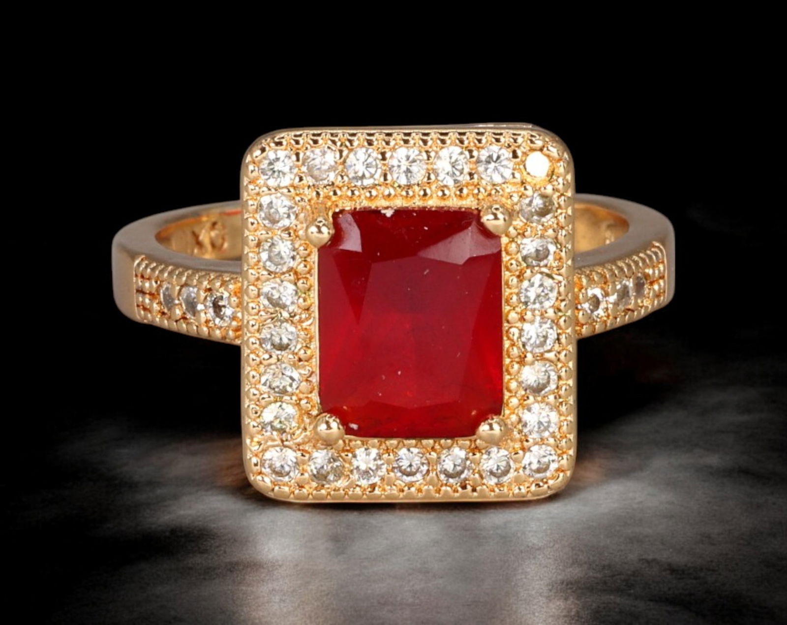 RETRO MODERN: Ring - Gold-Tone with Red Emerald-Cut Center and Pave Halo, US Size 8 (4g): A glamorous Retro Modern ring rendered in a warm gold-tone setting, showcasing a bold emerald-cut red centerpiece encircled by a sparkling pav? halo of white stones. The squared silhouette and precise