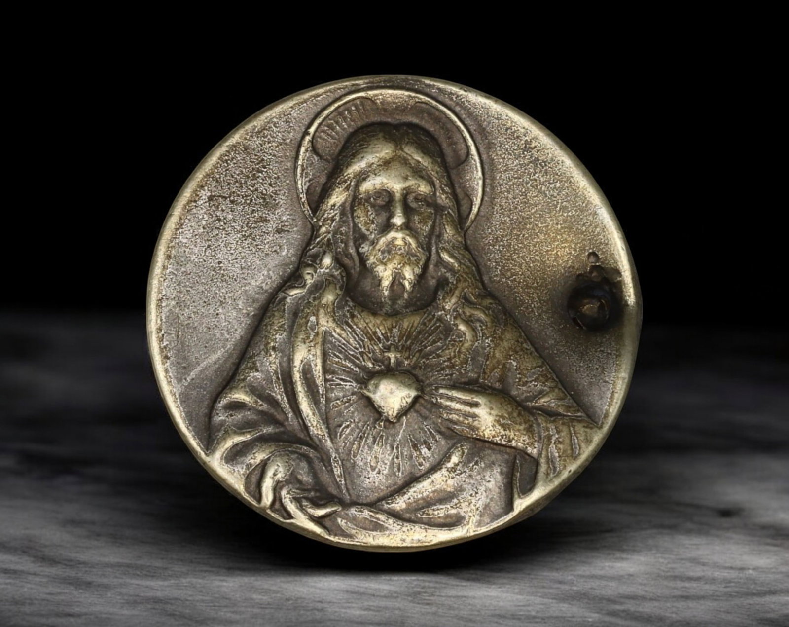 SPAIN: Sacred Heart of Jesus Medal - Devotional Badge with Cross & Vine Motif: A finely crafted silver-tone devotional badge featuring the Sacred Heart of Jesus in high relief, radiating divine mercy and compassion. The expressive portrait of Christ is masterfully detailed, evok