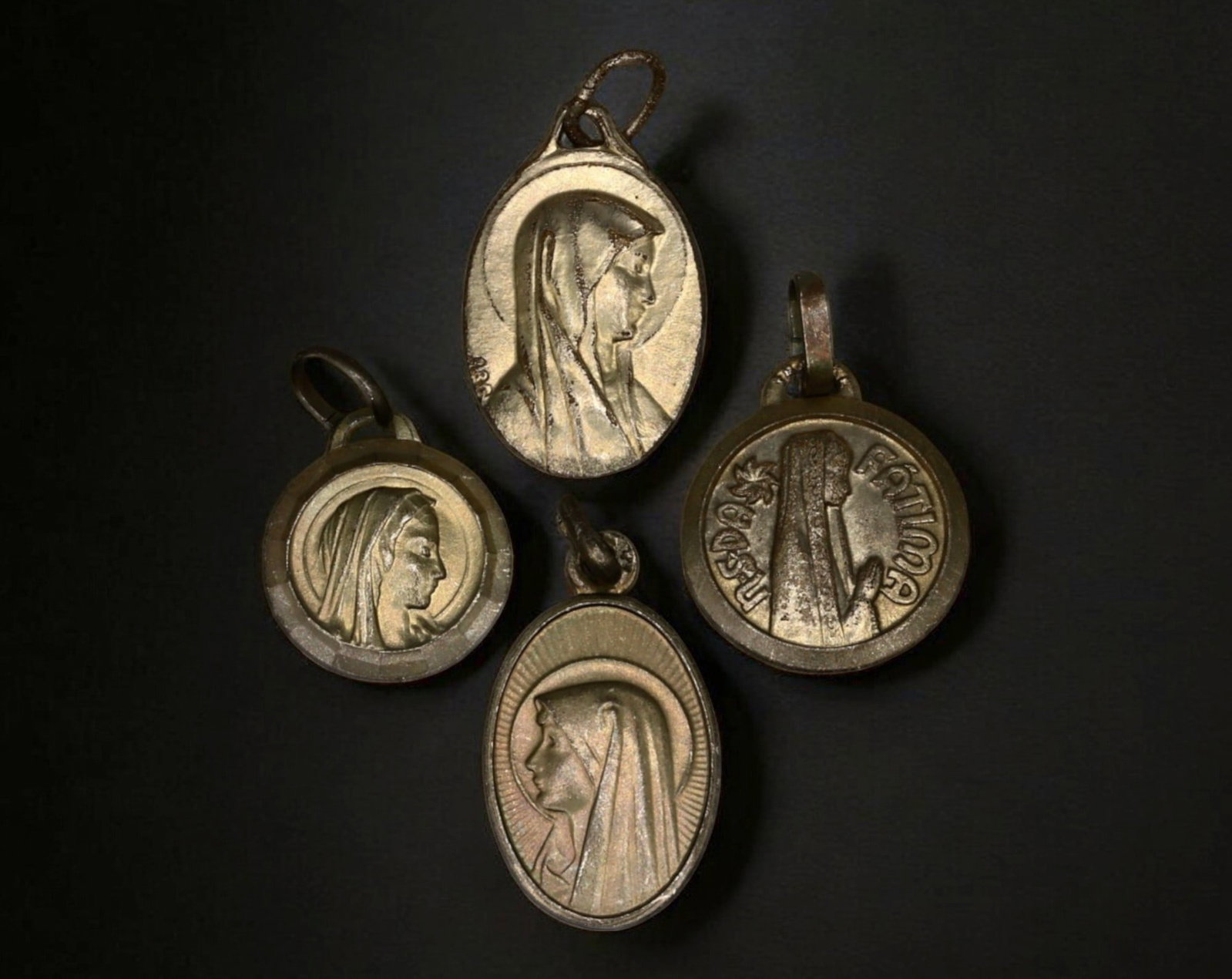 PORTUGAL & FRANCE: Our Lady of Fatima & Lourdes Pilgrimage Medal Set (4 Pieces): A finely detailed set of four silver-tone devotional medals, representing two of the most revered Marian apparitions in Catholic history-Our Lady of Fatima in Portugal and Our Lady of Lourdes in Franc