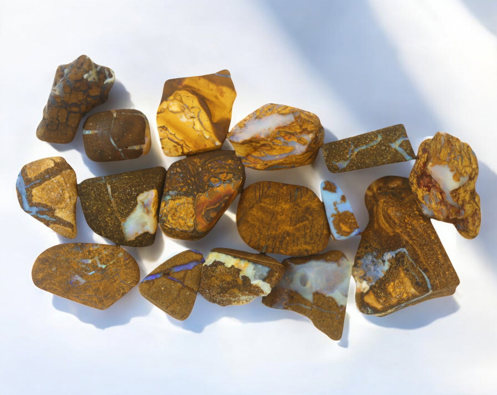 AUSTRALIA: Matrix Boulder Opal Rough Lot, 42g, 1-2.7 cm (Images Taken Wet): Stunning lot of natural Australian matrix boulder opal rough, these specimens showcase a vibrant interplay of opalized veins and swirls embedded in rich ironstone, displaying flashes of electric blues