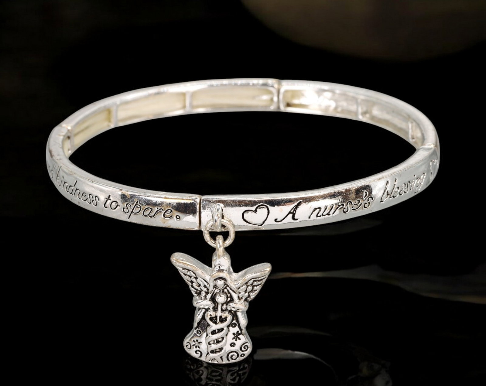 SENTIMENTAL JEWELRY: Bangle - Silver-Tone "Nurse's Blessing" with Angel Charm, 6.3cm (14g): A contemporary sentimental bangle crafted in silver-tone metal, engraved with the heartfelt phrase: 'A nurse's blessing: kindness to spare.' The hinged band measures 6.3 cm in diameter and features a 
