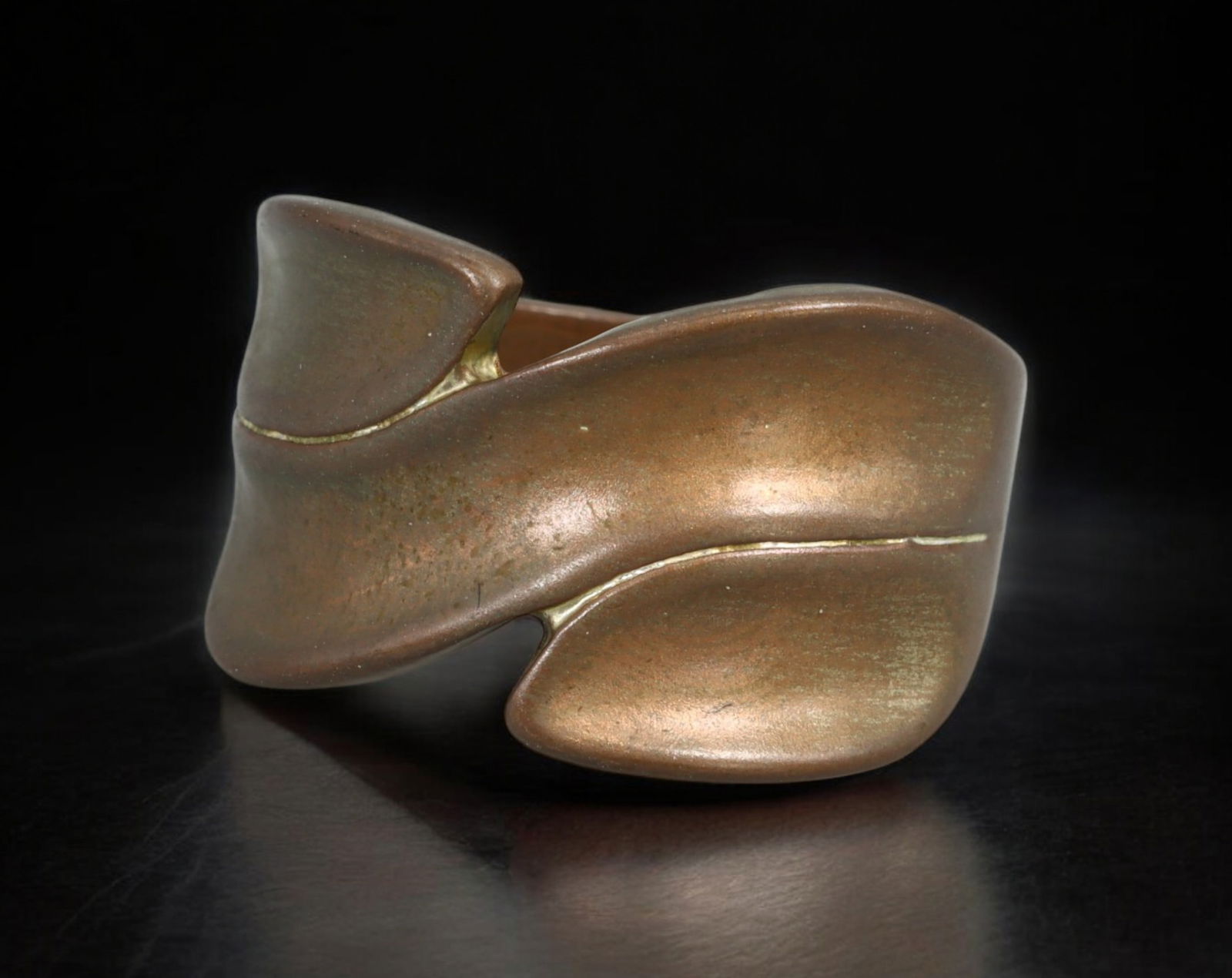 BRUTALIST: Ring - Sculptural Bronze Form with Organic Contour, US 9.2 (6.9g): A commanding Brutalist ring cast in a warm-toned bronze alloy, defined by sweeping curves and chiseled asymmetry. The abstract silhouette undulates around the finger in a fluid yet rugged contour, cre