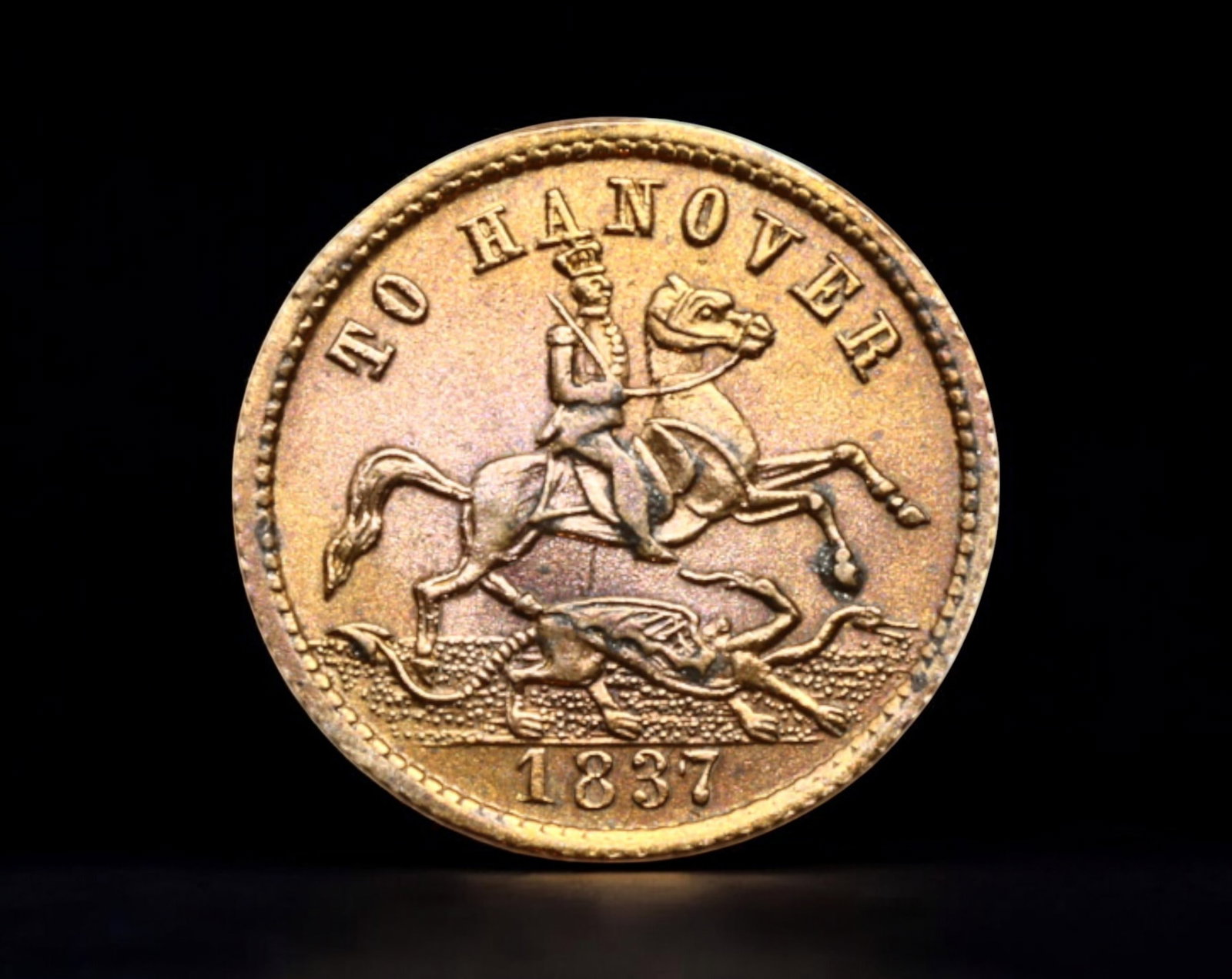 GREAT BRITAIN: "To Hanover" Token, 1837 - Queen Victoria & Duke of Cumberland: A satirical "To Hanover" token from 1837, struck in bronze, measuring 18mm in diameter and weighing 2.1g. These privately issued pieces were produced to mock the departure of Ernest Augustus, Duke of 