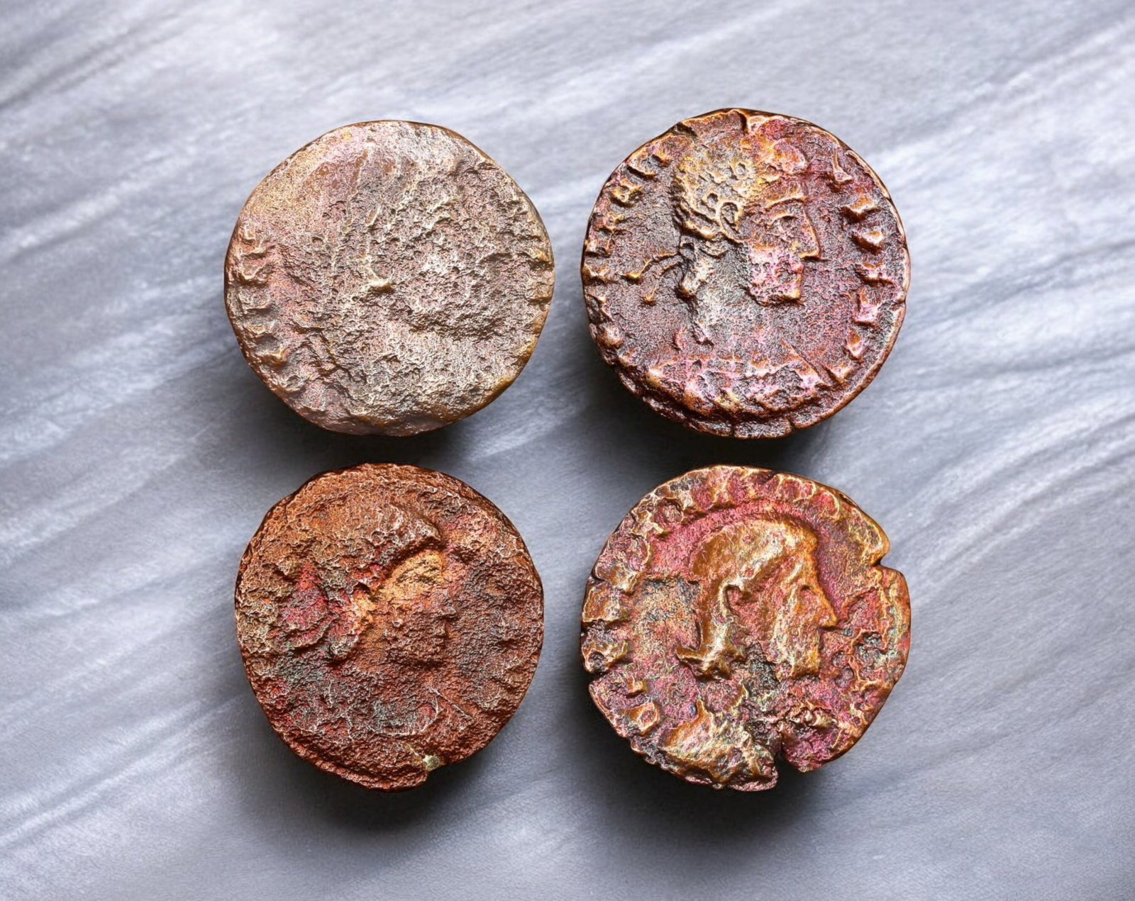 ROMAN EMPIRE: Lot of 4 Late Roman Bronze AE Coins 15-17mm, c. 3rd-5th Century AD: A mixed lot of four late Roman bronze AE coins, representing the turbulent era of the later empire. These coins likely feature emperors from the 3rd to 5th centuries AD, a period marked by military cr