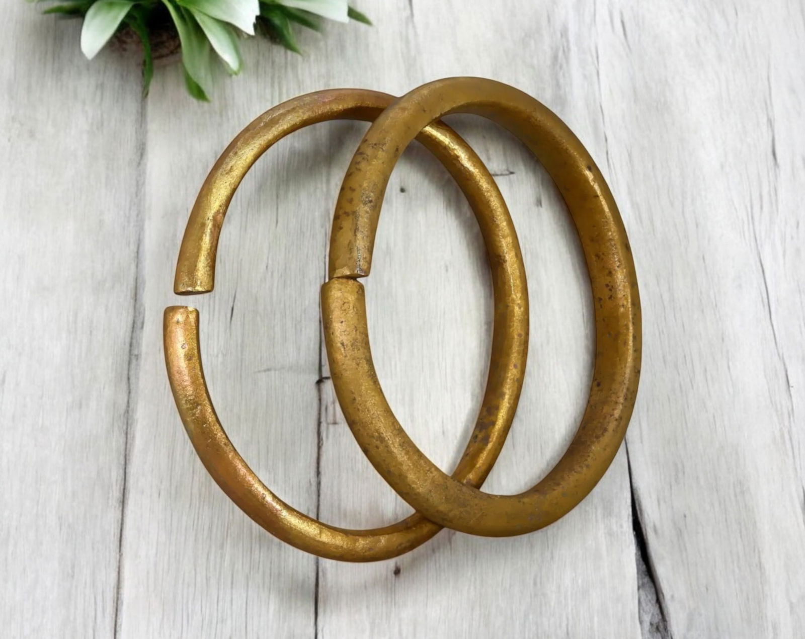 NIGERIA: Pair of Trade Manillas - Bronze Currency Rings, 19th-20th Century: A pair of traditional Trade Manillas, cast in bronze, measuring 9-9.2 cm in diameter with a combined weight of 231g. These pieces feature thick, rounded open-ended bands, a characteristic form of West