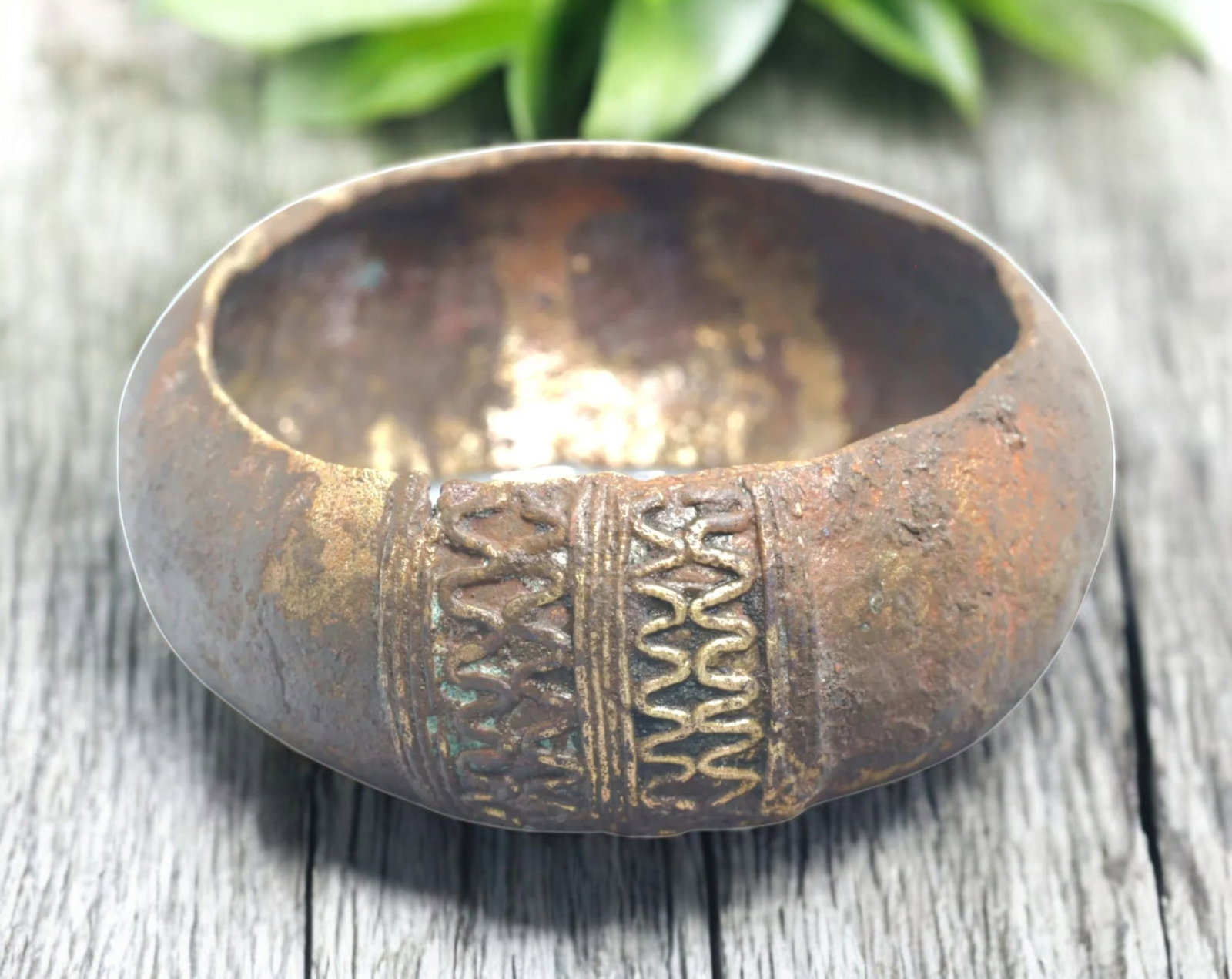WEST AFRICA: Fulani Bronze Currency Bracelet - 19th Century, 122g, 8.5cm: A finely cast Fulani bronze currency bracelet, measuring 8.5cm in diameter and weighing 122g. This piece showcases intricate raised geometric and linear patterns, a hallmark of Fulani metalwork from W