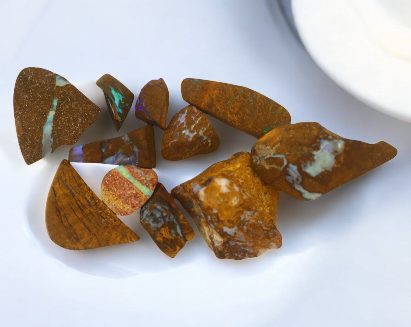 AUSTRALIA: Matrix Boulder Opal Rough Lot, 37g, 1-2.4 cm (Images Taken Wet): Stunning lot of natural Australian matrix boulder opal rough, these specimens showcase a vibrant interplay of opalized veins and swirls embedded in rich ironstone, displaying flashes of electric blues