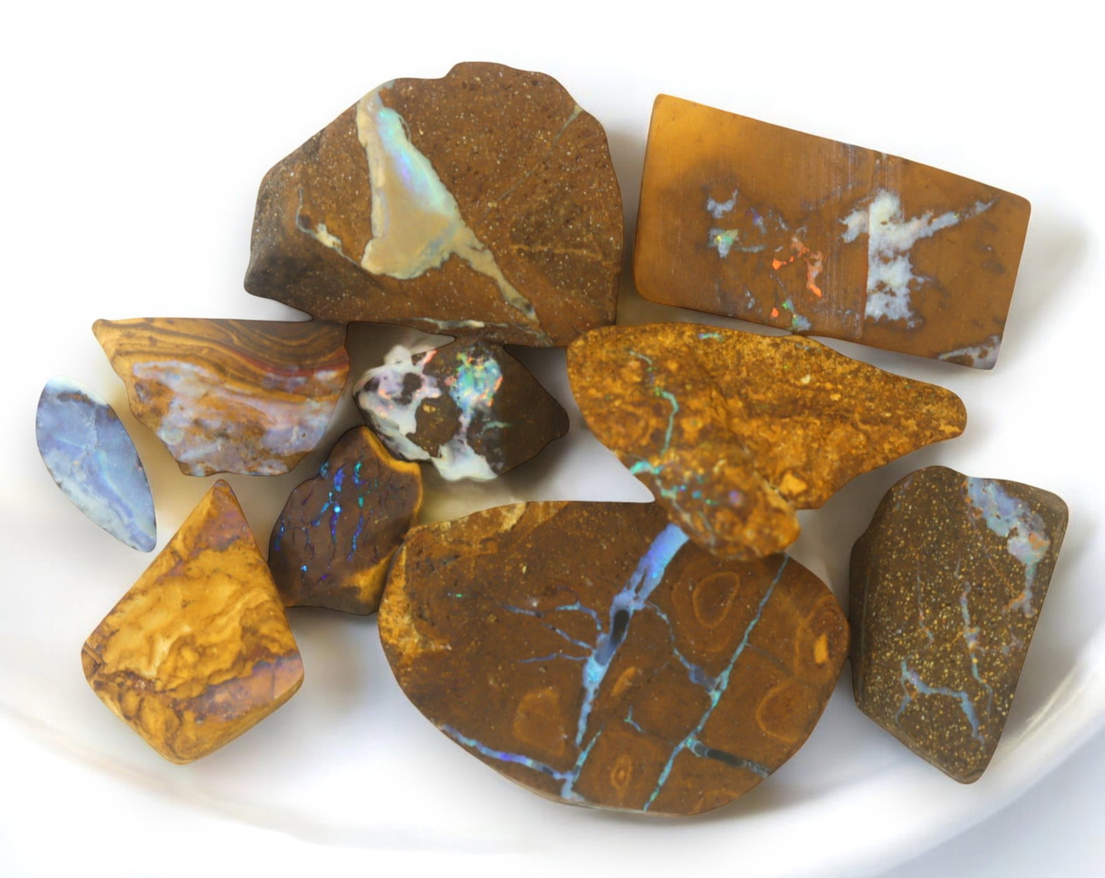 AUSTRALIA: Matrix Boulder Opal Rough Lot, 43g, 1-3.4 cm (Images Taken Wet): Stunning lot of natural Australian matrix boulder opal rough, these specimens showcase a vibrant interplay of opalized veins and swirls embedded in rich ironstone, displaying flashes of electric blues