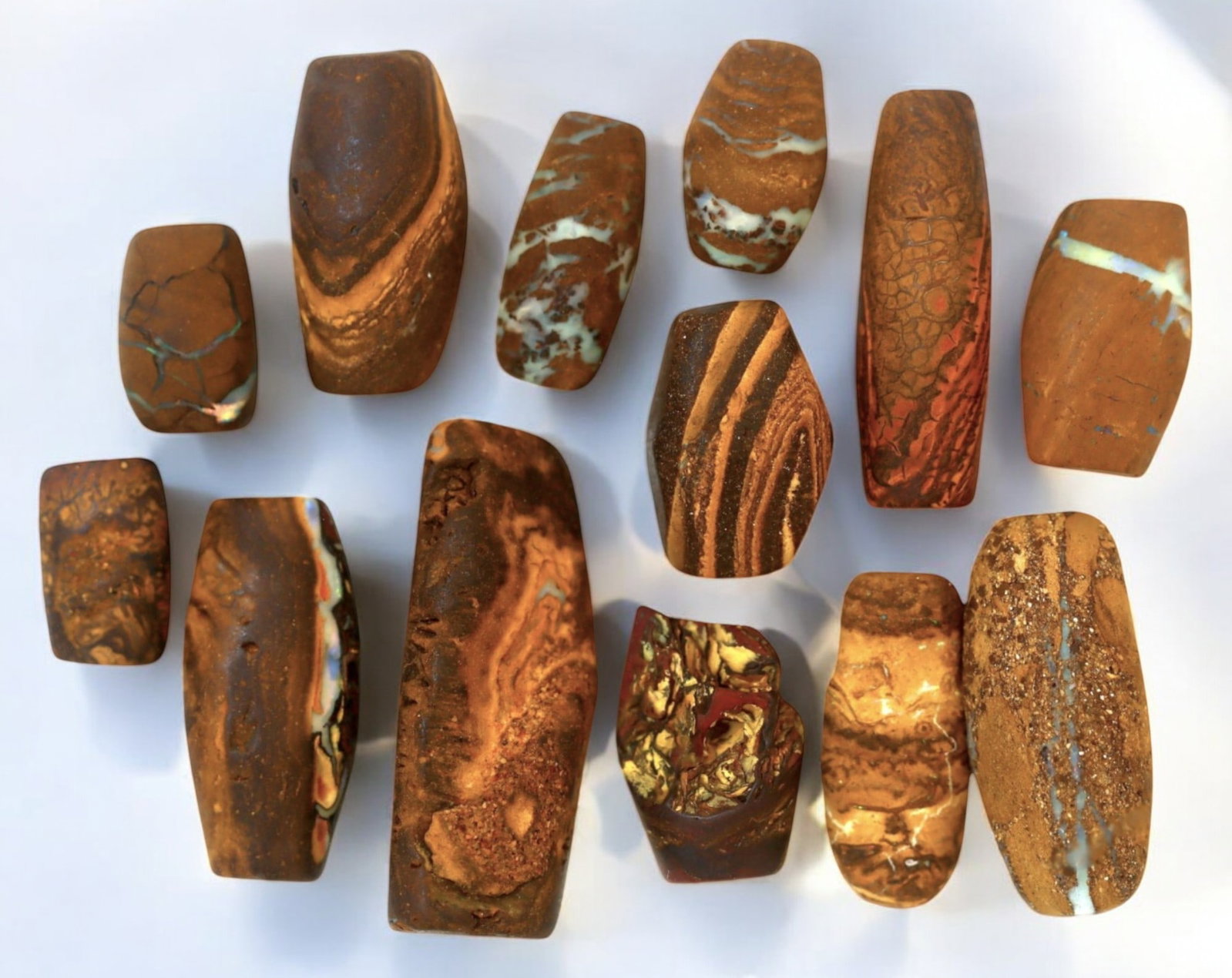AUSTRALIA: Matrix Boulder Opal Preform Rough Lot, 1-3cm, 38g: A stunning selection of matrix boulder opal rough, sourced from Australia's renowned opal fields in Queensland. These preform-cut rough specimens display vivid flashes of blue, green, and purple opale