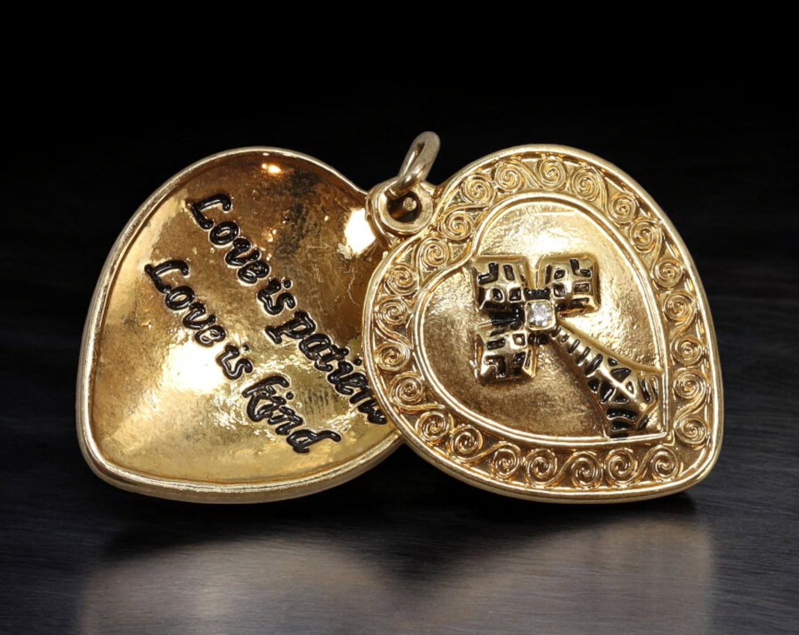 SENTIMENTAL JEWELRY: Heart Locket - Gold-Tone with Cross & Inscription, 2.8cm (5.2g): A heartfelt gold-tone locket in a double-heart form, featuring a raised ornamental cross at center adorned with black inlay and a single clear accent stone. The front heart is bordered with a spiral r