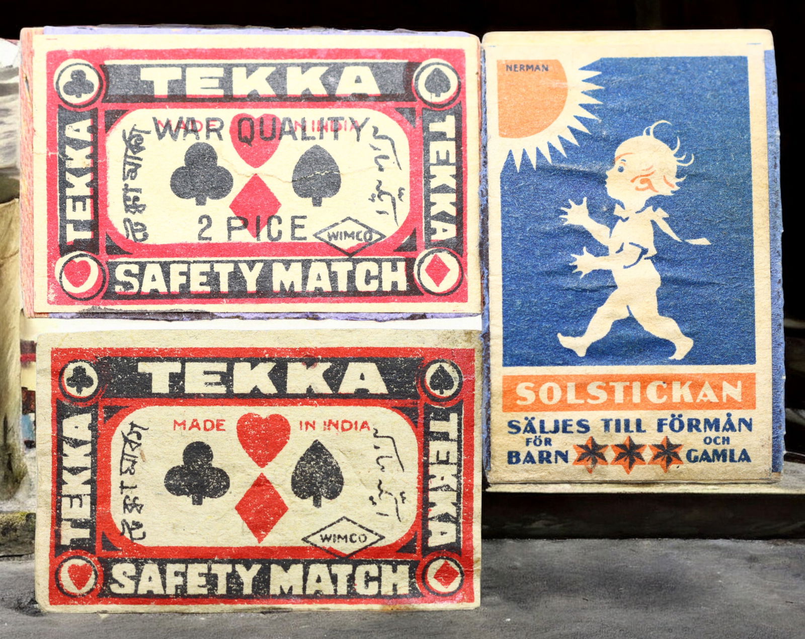INDIA/SWEDEN: Matchbox Labels - "Tekka" and "Solstickan," c.1930s-50s, 55-58mm: This trio combines striking Indian graphic boldness with Scandinavian social design. Two "Tekka" labels by WIMCO feature playing card suits-hearts, clubs, diamonds, and spades-framed within a black an