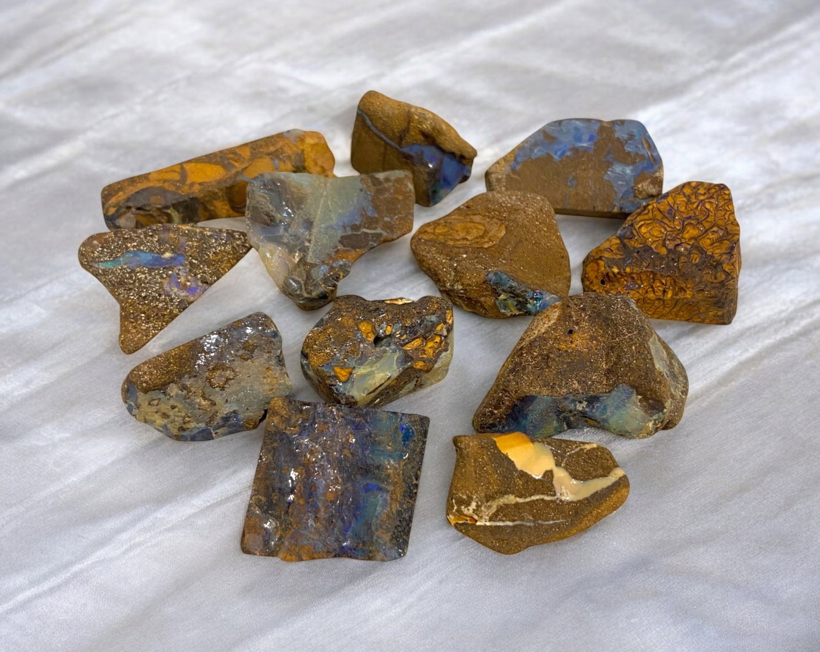 AUSTRALIAN MATRIX BOULDER OPAL - Rough Lot, 53g, 1.5-2.5cm Each: A striking lot of natural Australian matrix boulder opal rough, weighing a total of 76g, with individual pieces ranging from 2-3cm in size. These raw specimens display mesmerizing flashes of blue, gre