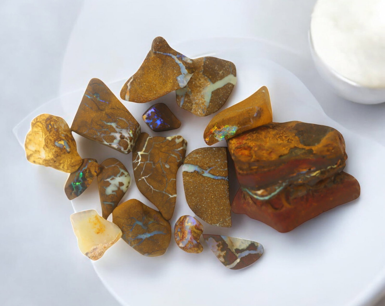 AUSTRALIA: Matrix Boulder Opal Rough Lot, 62g, 0.8-2.9 cm (Images Taken Wet): Stunning lot of natural Australian matrix boulder opal rough, these specimens showcase a vibrant interplay of opalized veins and swirls embedded in rich ironstone, displaying flashes of electric blues