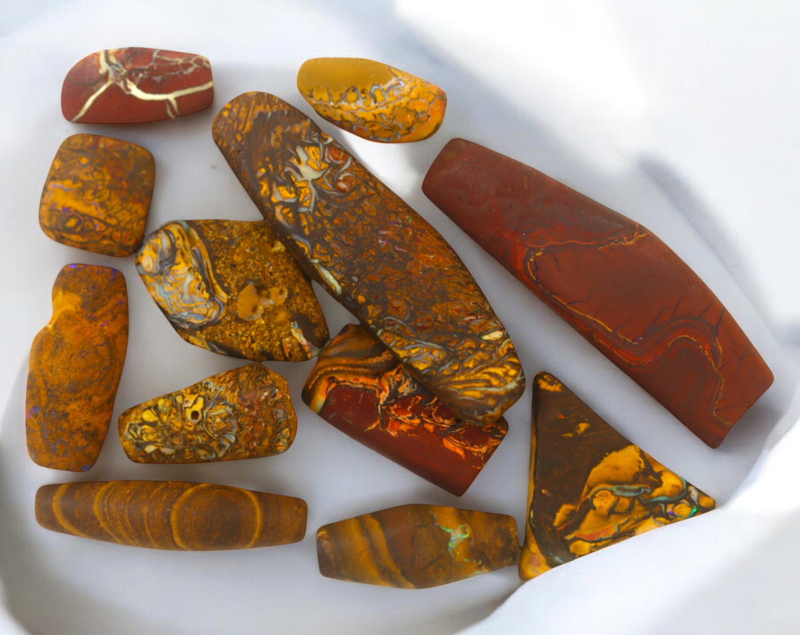 AUSTRALIA: Matrix Boulder Opal Preform Rough Lot, 47g, 1-4.1cm Each: A stunning selection of matrix boulder opal rough, sourced from Australia's renowned opal fields in Queensland. These preform-cut rough specimens display vivid flashes of blue, green, and purple opale