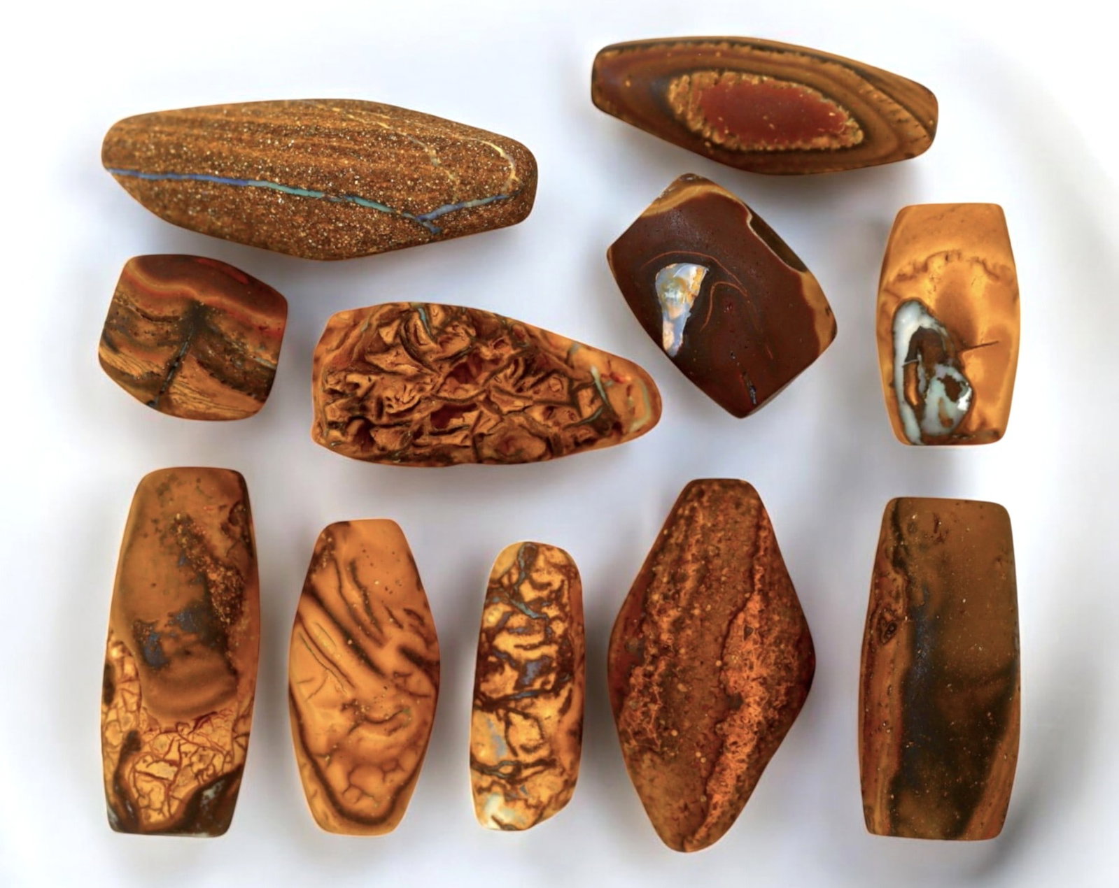 AUSTRALIA: Matrix Boulder Opal Preform Rough Lot, 1-2.9cm, 40g: A stunning selection of matrix boulder opal rough, sourced from Australia's renowned opal fields in Queensland. These preform-cut rough specimens display vivid flashes of blue, green, and purple opale