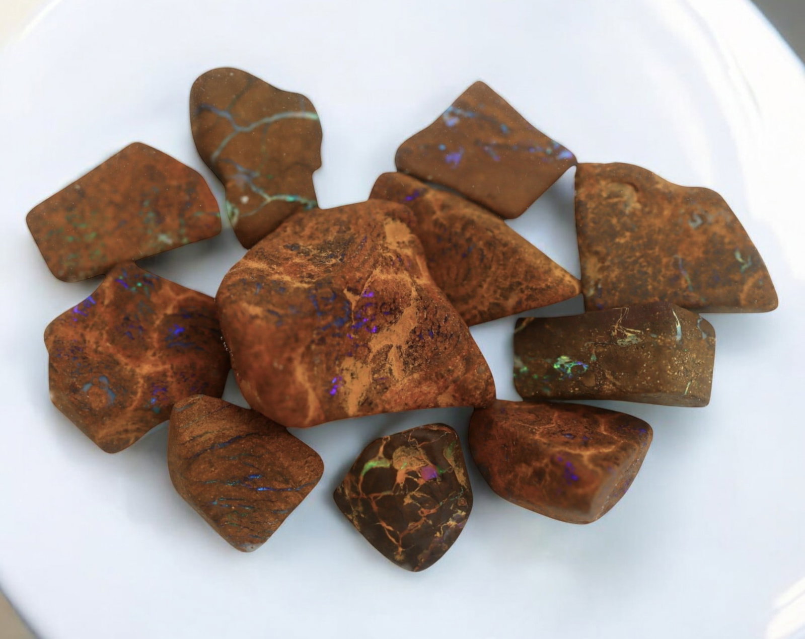 AUSTRALIAN MATRIX BOULDER OPAL - Rough Lot, 1.3-3cm, 36g: A striking lot of natural Australian matrix boulder opal rough. These raw specimens display mesmerizing flashes of blue, green, and gold veins running through ironstone, characteristic of high-quality