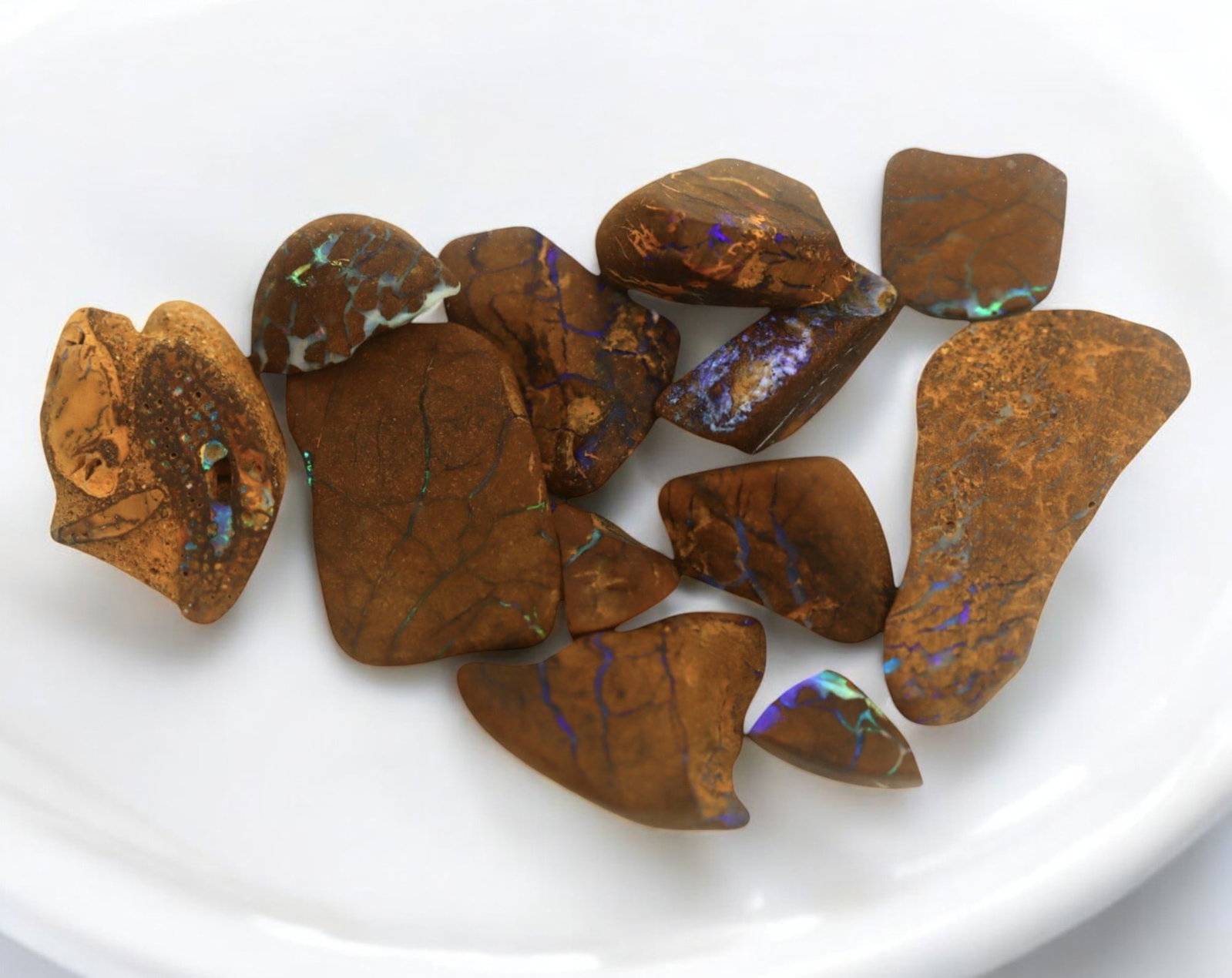 AUSTRALIAN MATRIX BOULDER OPAL - Rough Lot, 1-3cm, 26g: A striking lot of natural Australian matrix boulder opal rough. These raw specimens display mesmerizing flashes of blue, green, and gold veins running through ironstone, characteristic of high-quality