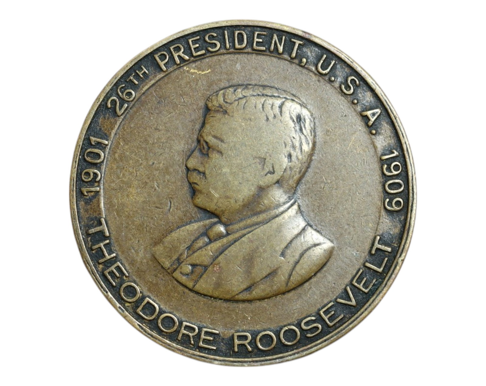 USA: Theodore Roosevelt - 26th President Commemorative Coin, 1901-1909 (26mm): Issued in honor of the dynamic 26th President of the United States, this 26mm brass commemorative coin profiles Theodore Roosevelt, noted for his vigorous reformist agenda and iconic presence in early